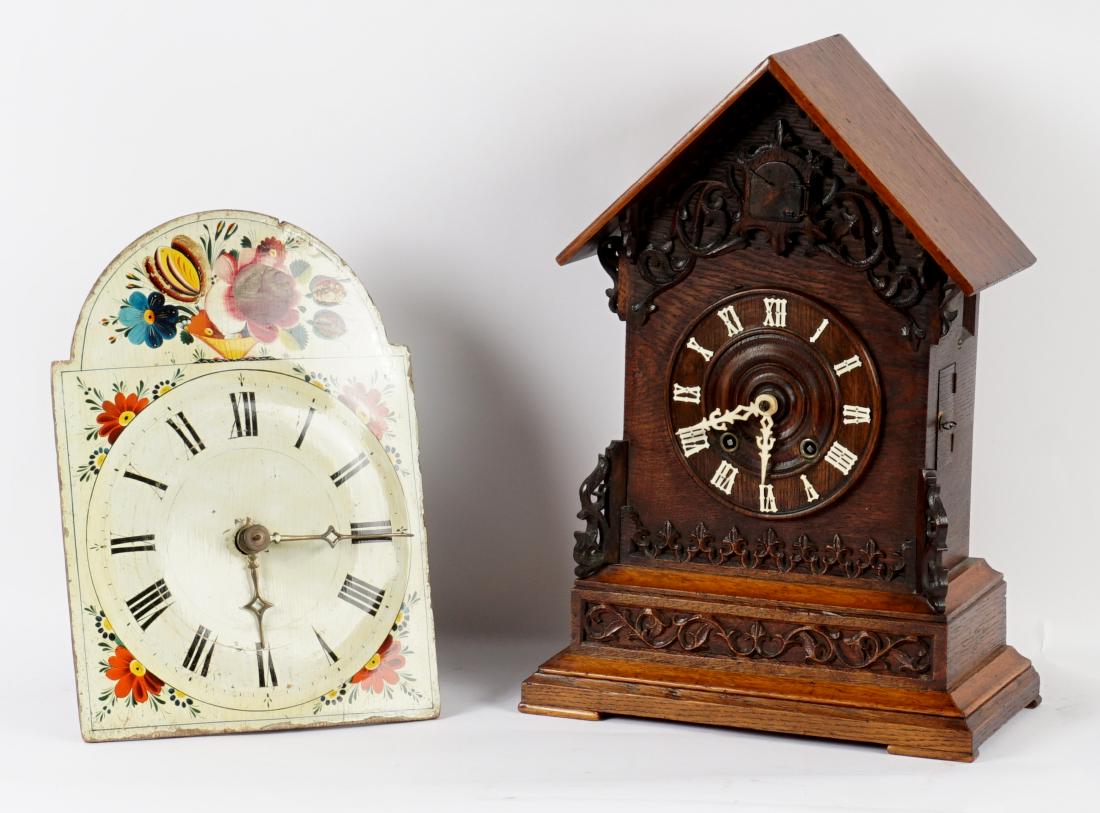 Two Continental Mantle and Wag on the Wall Clocks: Two pieces total to include 1) German Black Forest carved mantle cuckoo clock, walnut case with applied decoration, 18" h. x 12.75" x 6.75". 2) French Wag on the Wall clock, floral painted wood dial,