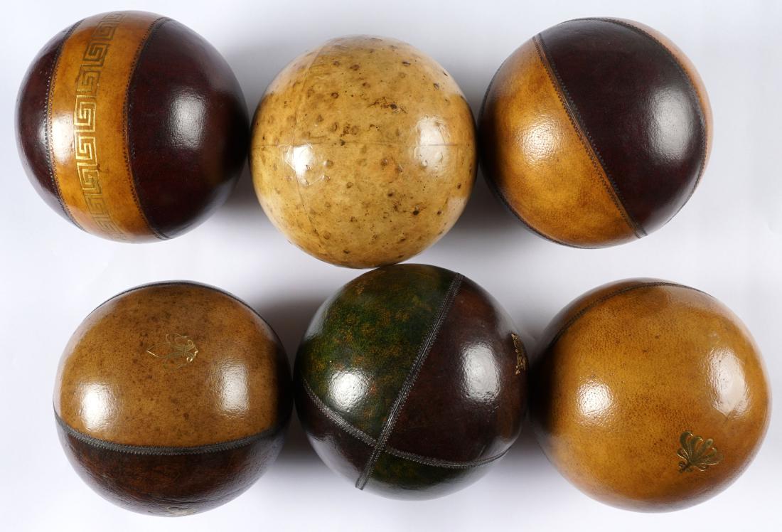Six Leather Bocce or Lawn Bowls Balls: A collection of six, each with a different pattern, several with embossed gilt accents. Approx. 6" dia.