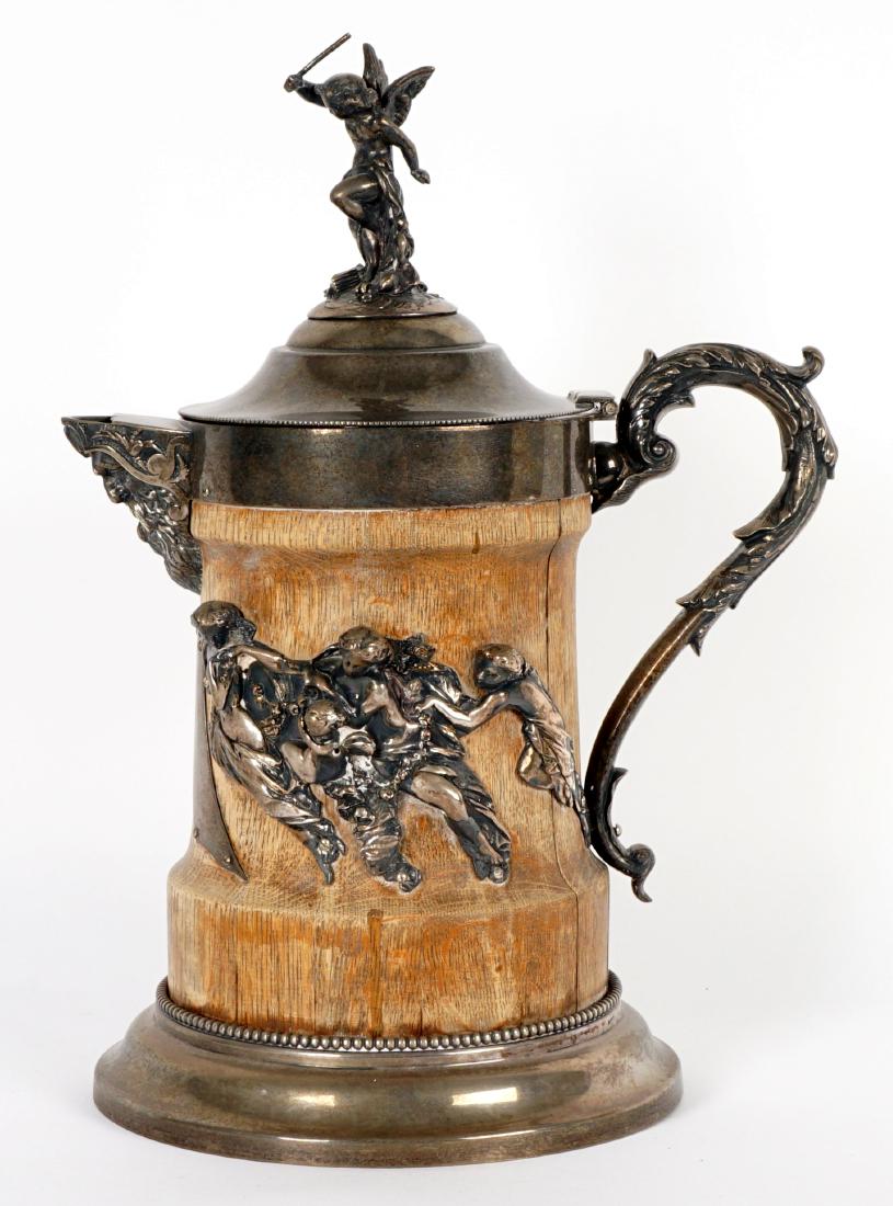 Bourne and O'Neill Wood and Silverplate Pitcher: Silverplate hinged lid with figural angel finial, masqueron spout, foliate scroll handle, wood body with applied neoclassical designs, flared foot. Marked on base with Henry Bourne and Daniel J. O'Nei