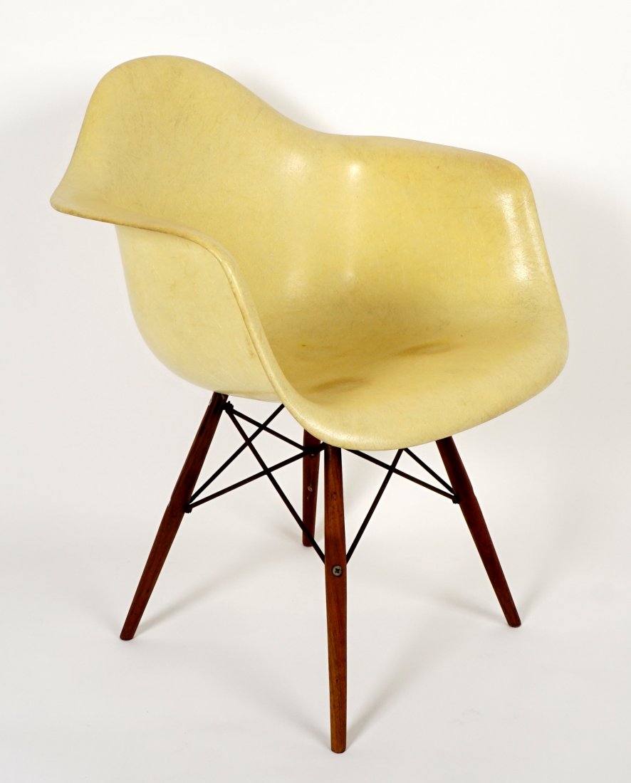 Ray and Charles Eames Dowel Leg Shell Chair: Yellow fiberglass arm chair, wood dowel legs with wire supports, partial original Herman Miller and Zenith Plastics tags underneath. 30.5" h. x 24.75" 23.5". Toning.