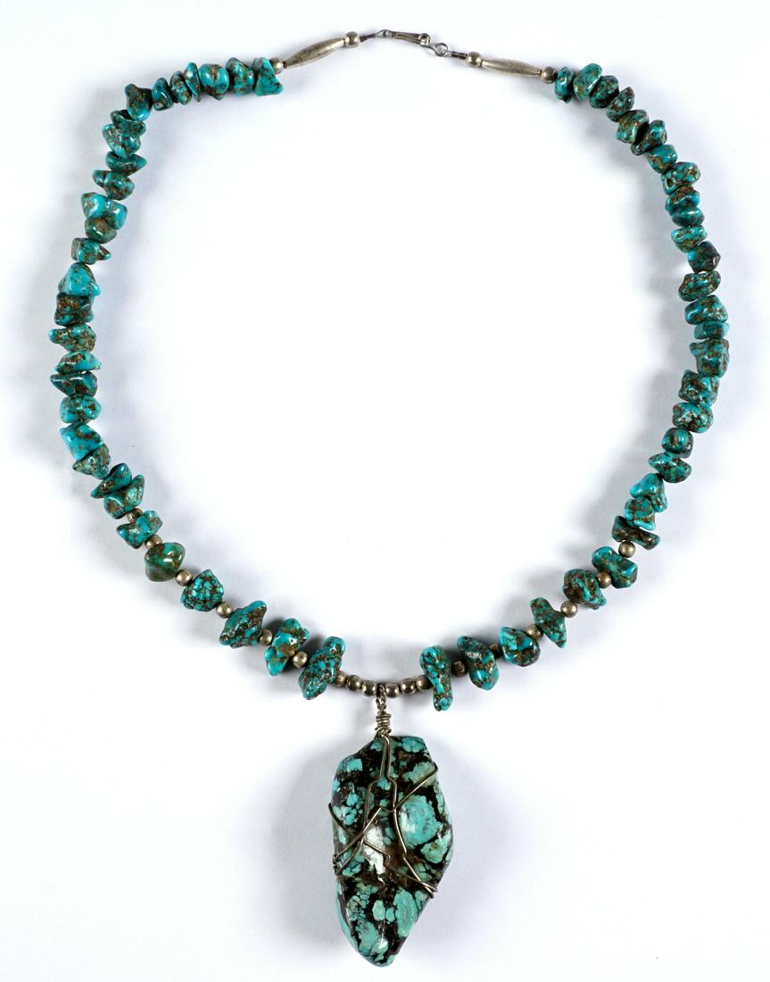 Early 20th C Navajo Turquoise and Silver Necklace: Circa 1910-1930, large nugget pendant measures 70mm x 35mm, necklace with silver beads and turquoise stones, measures 22.5" long. No visible markings.