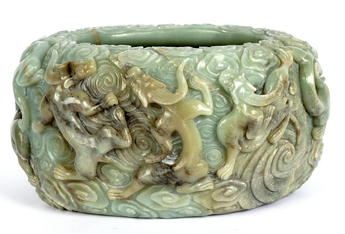 Large Chinese Carved Jade Bowl: 20th Century, heavy large jade or similar stone bowl with carved Qilin and clouds motif exterior. Overall 6.75" h. x 14" x 11.25". Condition: Natural fissures, shippers note very heavy, approx. 32 lbs