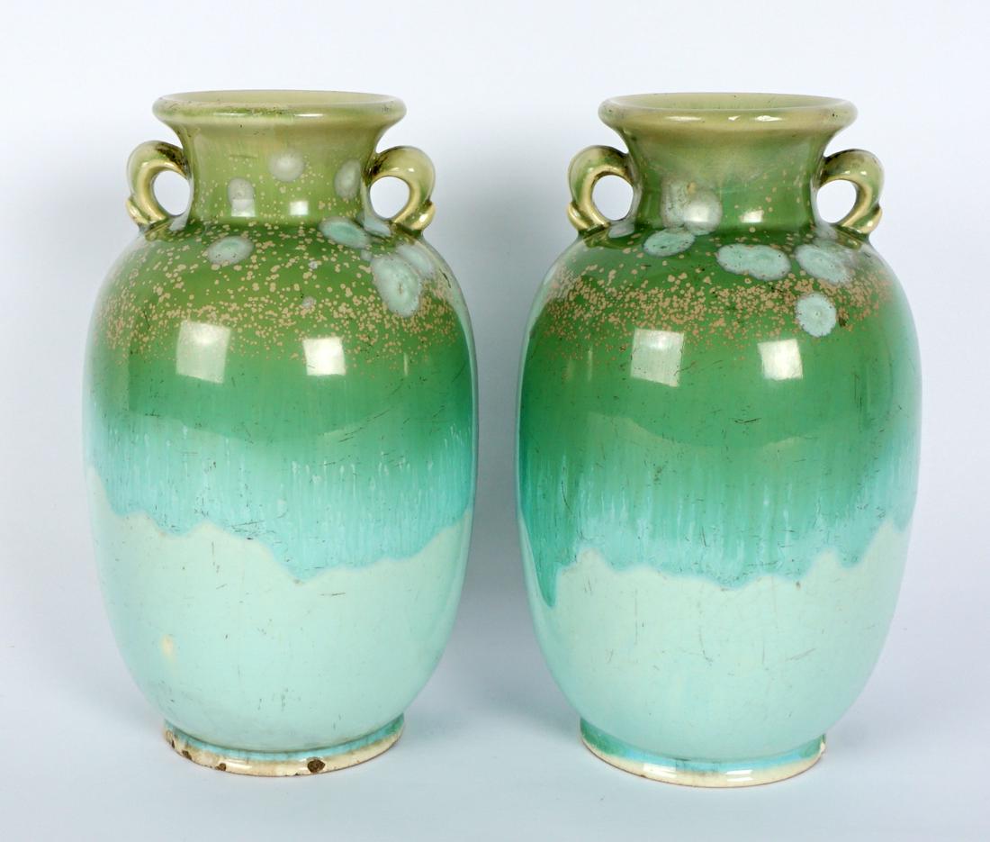 Pair Crystalline Glaze Art Pottery Vases: Ovoid form with flared rims and applied handles, crystalline glaze with blue and green hues, tan spots, no markings, 7.5" h. x 4.25". Condition: Repairs to both rims, chips to both feet, crazing, scra