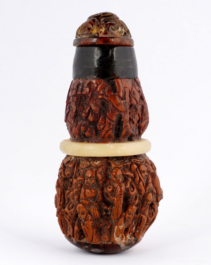 Nepalese Carved Wood Snuff Bottle w/ Jade Ring: Profusely carved all over with multiple figures and foliate motifs, jade center ring, carved amber stopper, 3" h.