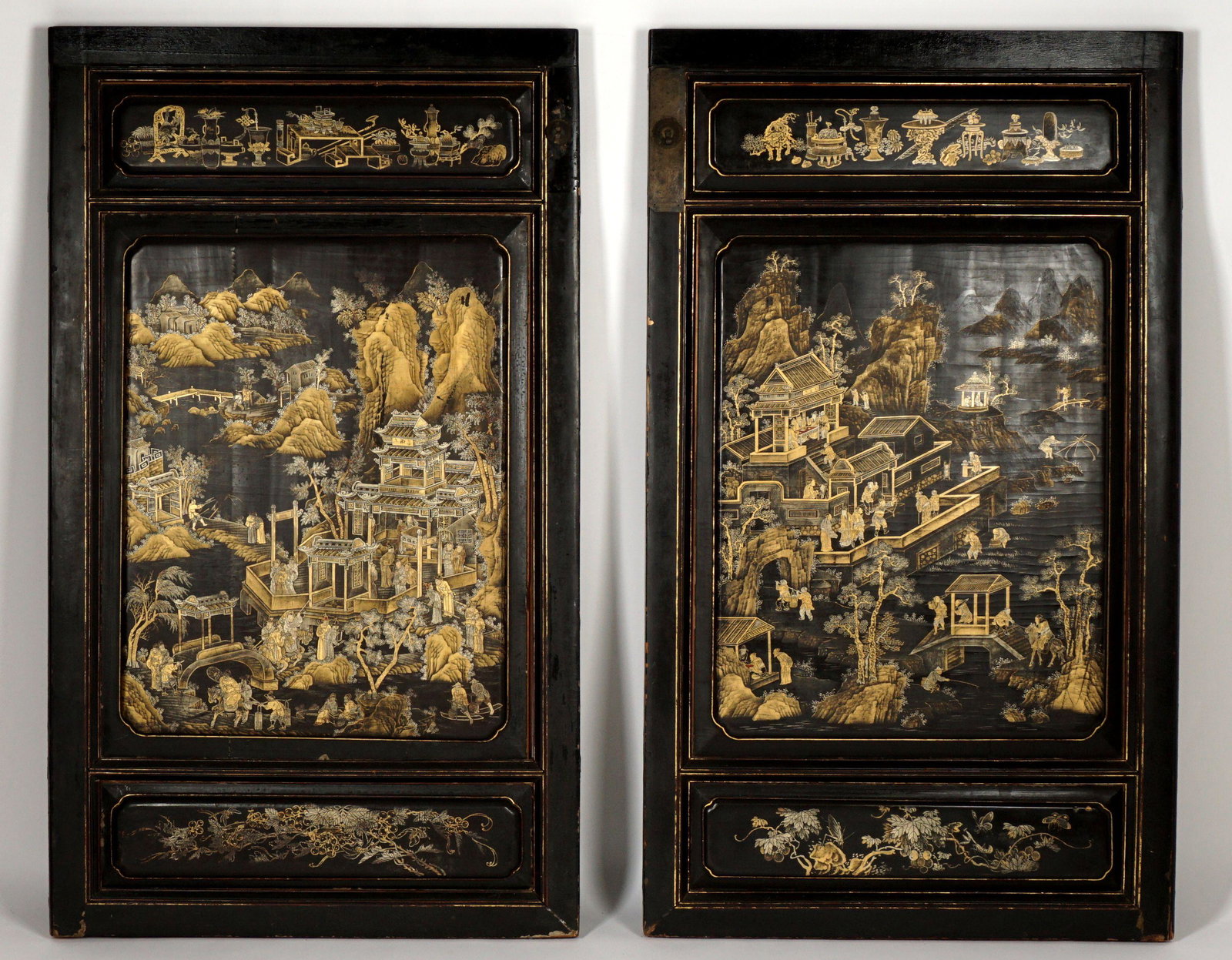 Pair Chinese Black Lacquer Chinoiserie Panels: 19th Century, each with elaborate and well executed chinoiserie decorated landscapes in center panel, upper panels with household items, lower panel with grape vine and butterflies. Overall 58.25" h.