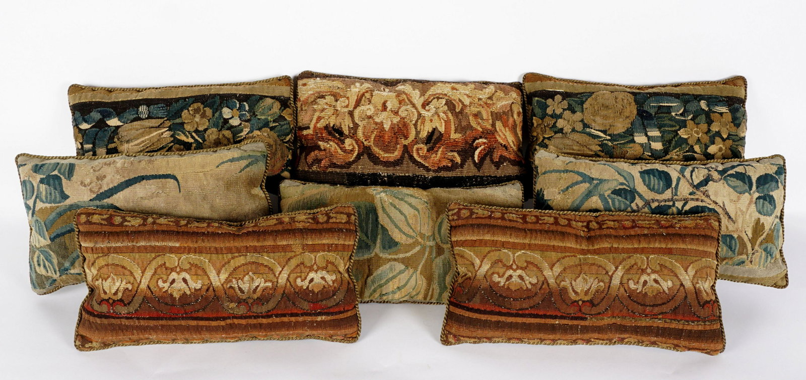 Eight 18th Century Aubusson Throw Pillows: Eight throw pillows constructed from 18th Century aubusson tapestry remnants, suede backs, each approx. 16.75" x 9.5" x 4".