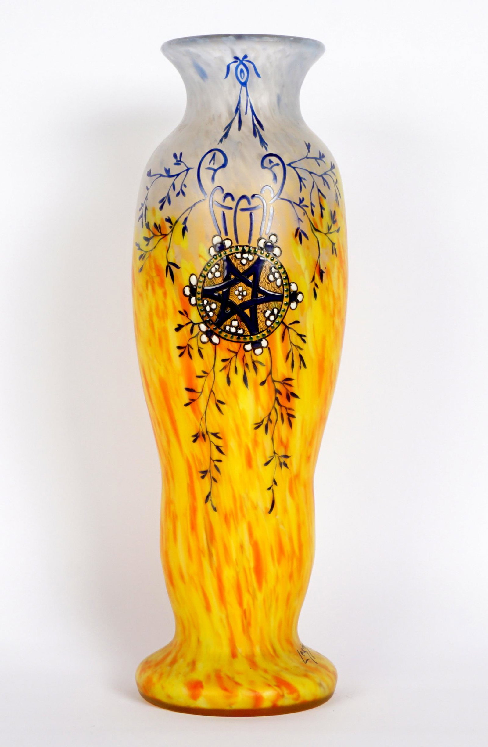 Legras Enameled Art Glass Vase: Serpentine form body mottled blue graduating to orange frosted glass, enamel foliate motif with center six point star, signed at flared foot. Overall 14.5" h. x 4.75".