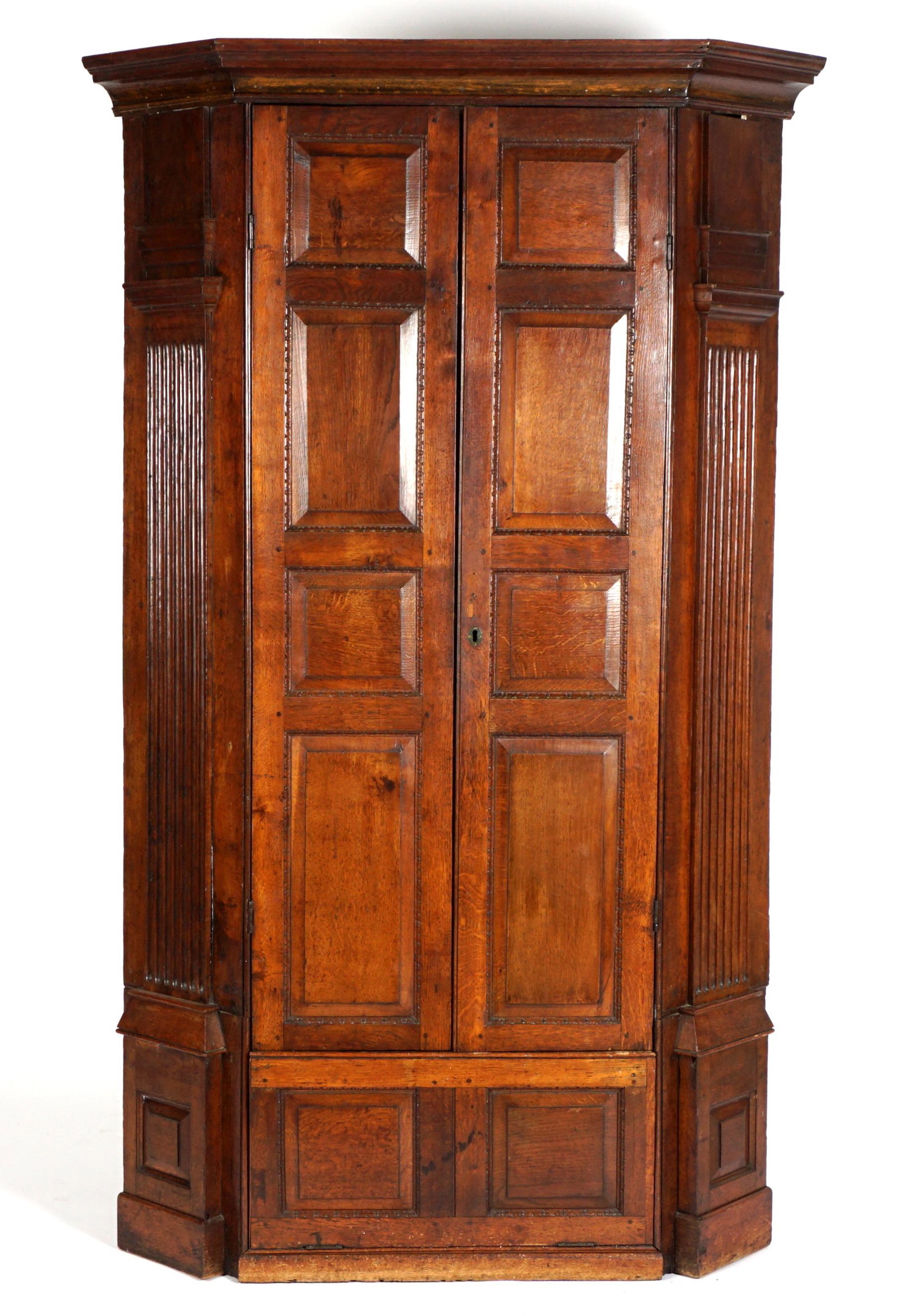 18th Century Oak Architectural Corner Cabinet: Molded cornice over two paneled blind doors over fall front door, fluted architectural accents, painted interior with fixed shelves. Overall 77" h. x 47" x 31.5". Condition: Wear consistent with age a