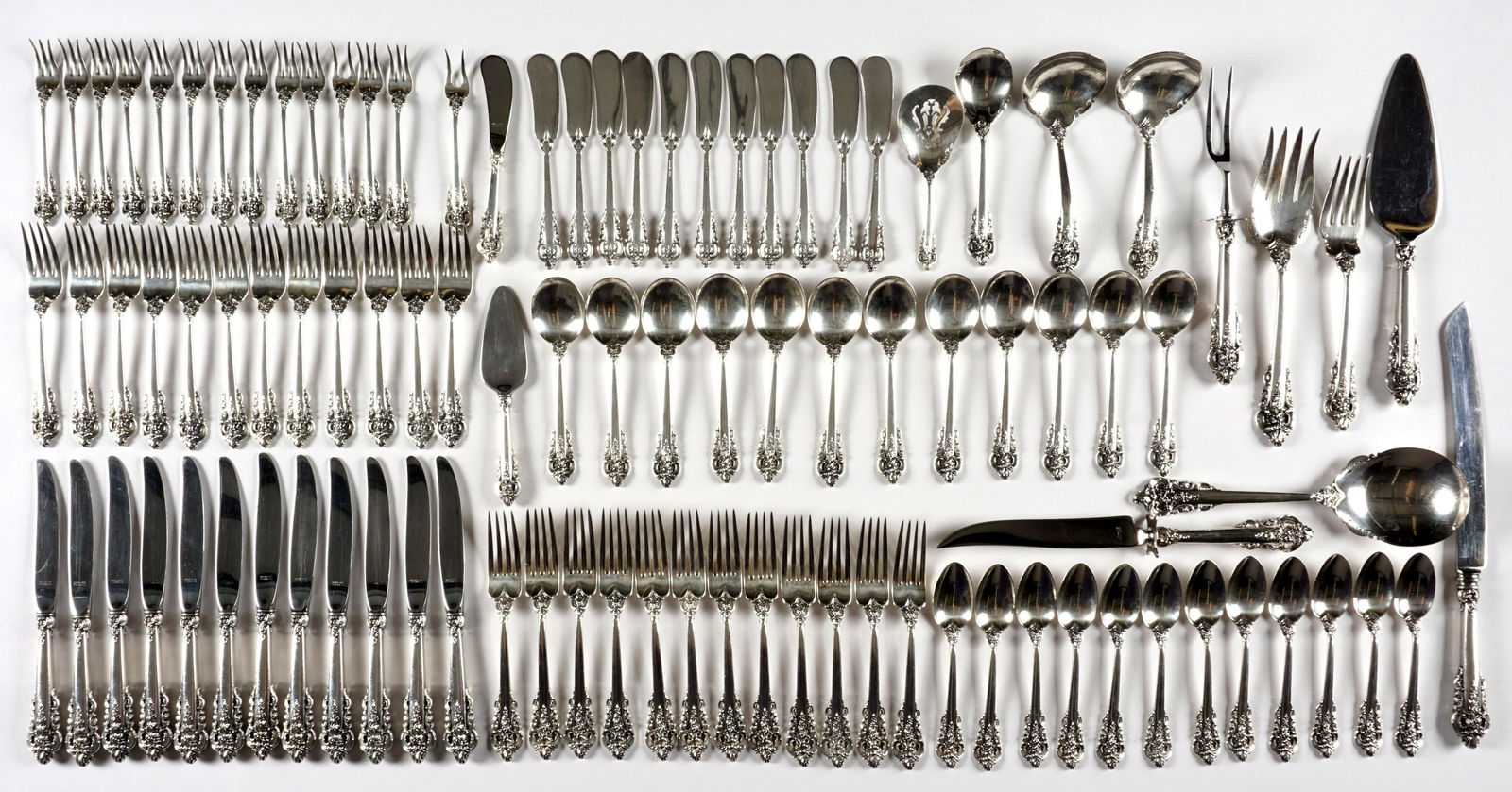 98 Piece Wallace Grand Baroque Sterling Flatware: Approx. 98 piece in the Grand Baroque pattern by Wallace Silversmiths to include 12 dinner forks (7.5"), 12 salad forks (6.5"), 12 teaspoons (6"), 12 soup spoons (6"), 12 cocktail forks (5.25"), 2 lem