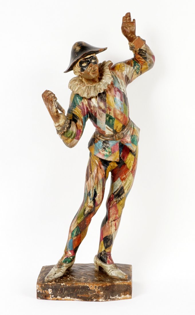 18th/19th C Italian Carved Polychrome Harlequin: Standing figure of a harlequin, masked face, polychrome decorated costume, 26" h. x 12" x 6.5". Condition: Finger loss, crack to base, loss of scepter, wear to paint.