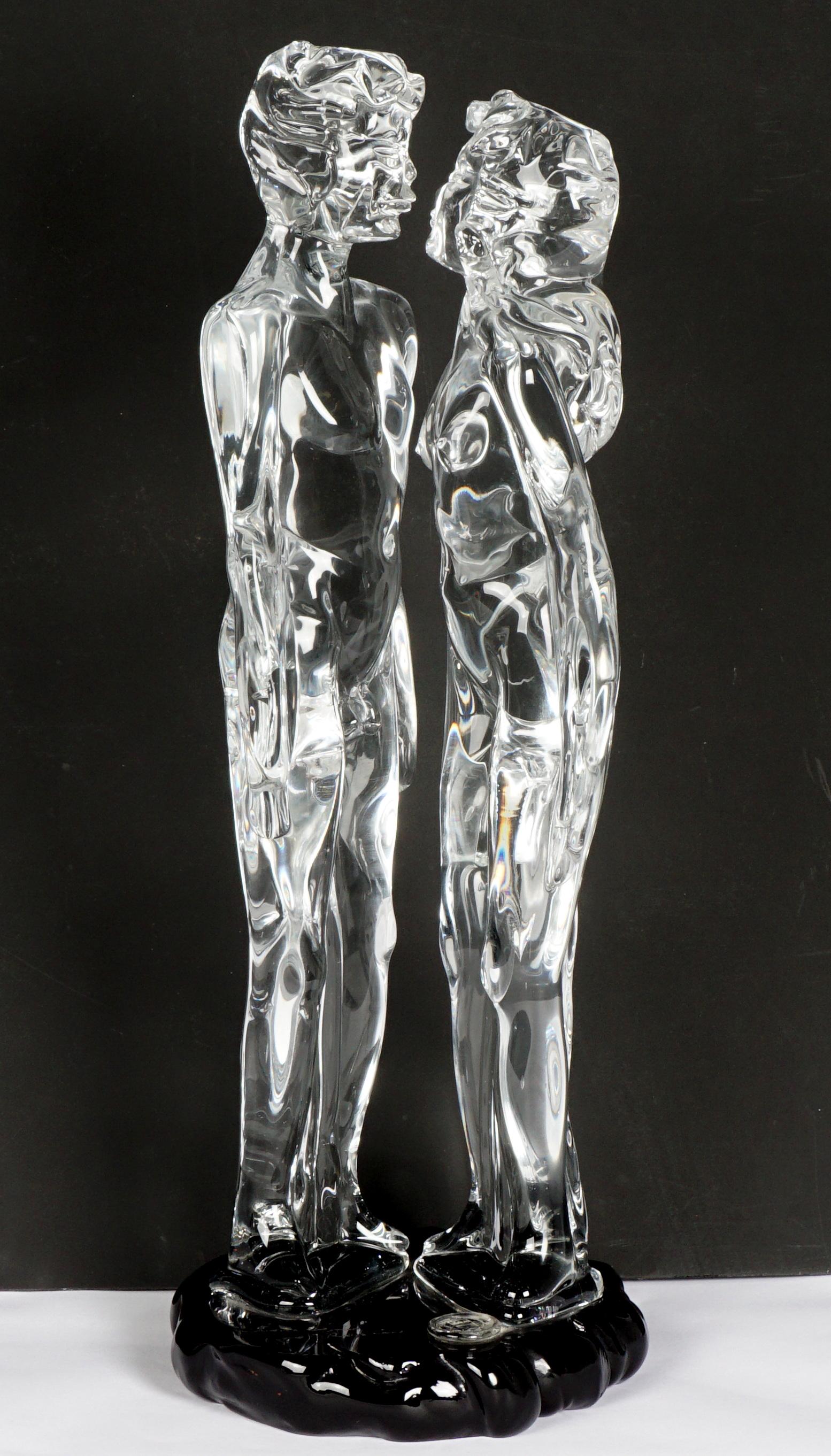 Loredano Rosin Crystal "Amanti" Lovers Sculpture: ROSIN, Loredano, (Italian, 1936-1992): Clear crystal figural group of two nude lovers, signed on black glass base with raised Murano seal. Sold with original 1985 certificate and pamphlet. Overall 26"
