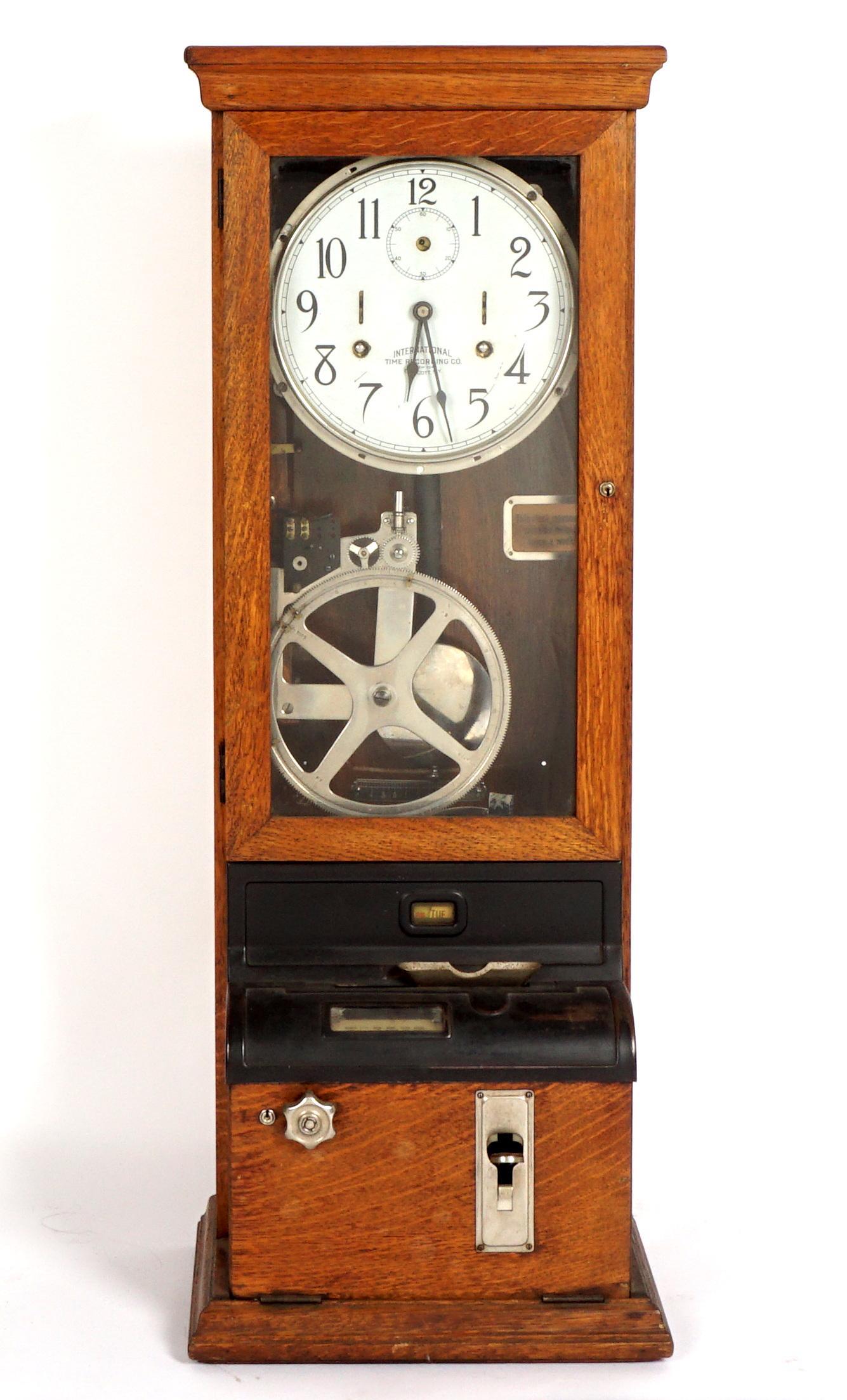 Oak International Time Clock from Stickley Furn.: Reputedly from the Stickley Furniture manufacturing plant, International Time Recording Company punch clock, oak case, painted metal dial, punch clock frame. Delivery tag inside case with Stickley fac