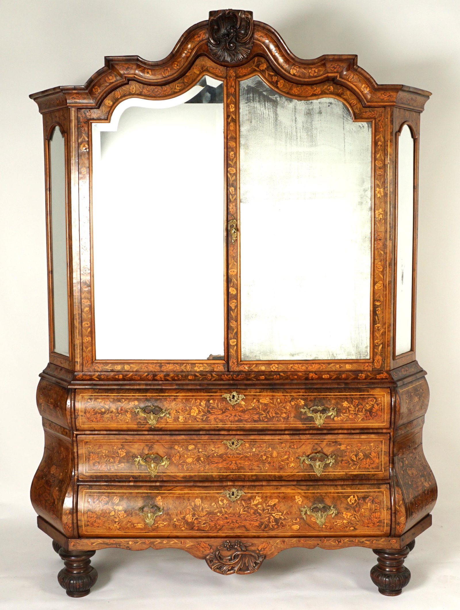 18th C Dutch Marquetry Mirrored Cabinet: Circa Mid 18th Century, shaped crest with center carved foliate medallion over 2 mirrored doors, mirrored sides, 2 serpentine interior shelves. Profuse floral fruitwood marquetry all over. 3 full leng