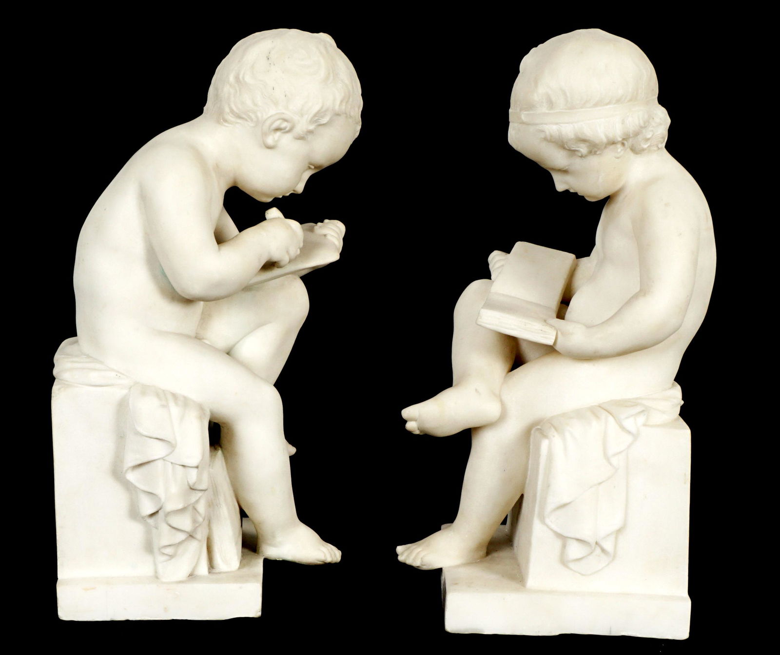 Pair A. Piazza Carved Marble Studious Putti: PIAZZA, Antonio, (Italian, 19th/20th Century): Pair of carved figural seated putti, one reading a book, the other writing on a tablet, signed A. Piazza, dedicated and dated 1890. Each measures 16.5" h