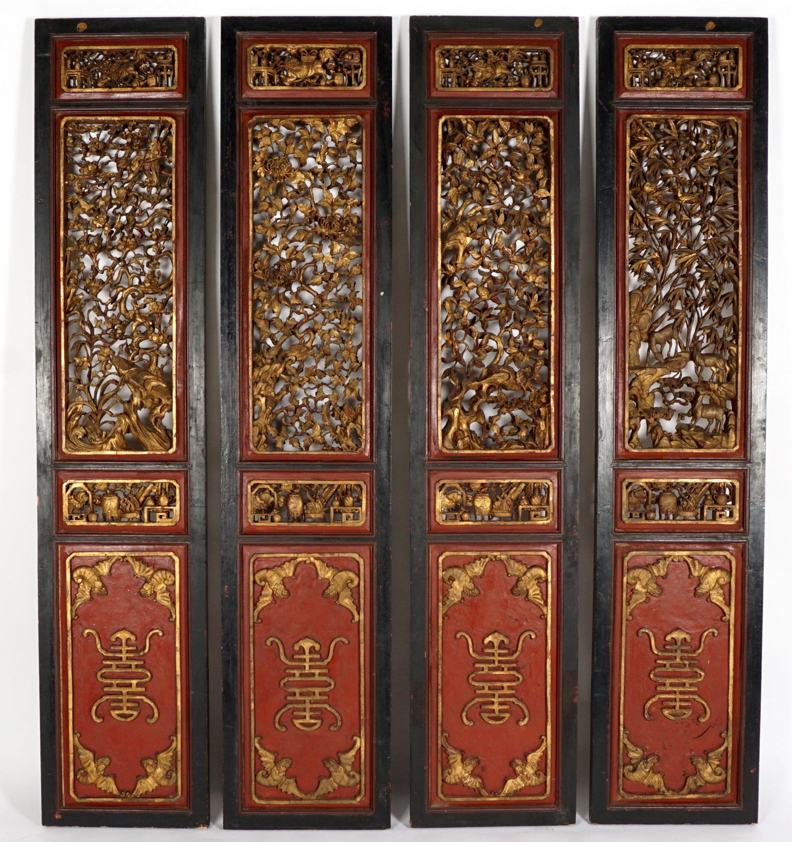 Chinese 4 Panel Coromandel Screen: Impressive four panel floor screen, each panel with red and black decorated frames, reticulated pierced gilt wood top sections, lower section obverse with bats and characters, reverse with various mot