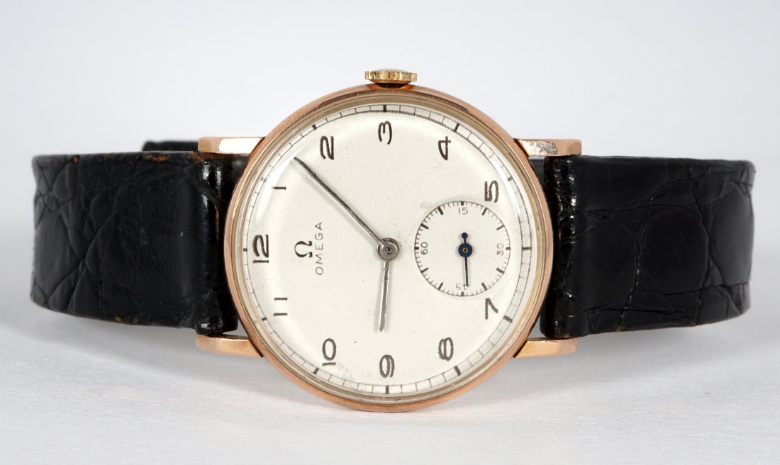 Vintage Omega Rose Gold Wristwatch: Porcelain dial, Arabic numerals, # 6, second aperture, rose gold back, Champion black alligator band, approx. 28mm dia back. 8.75" long, currently running.