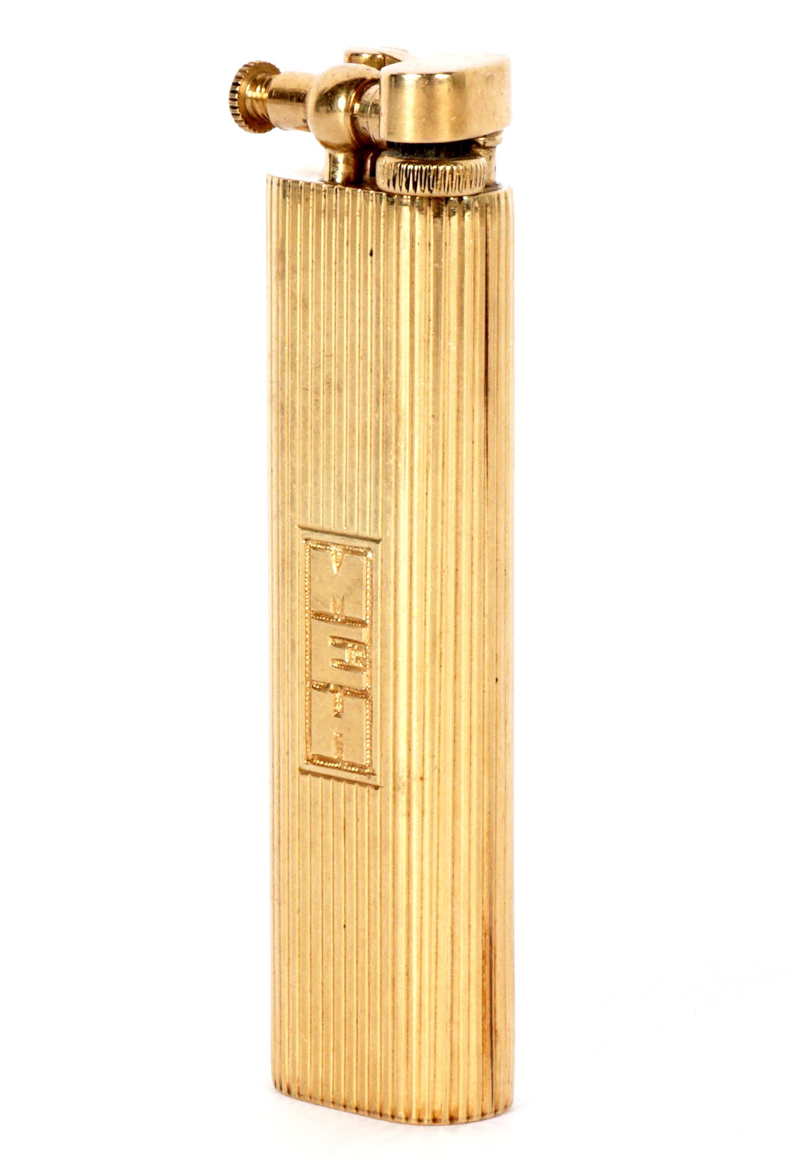Vintage 14K Yellow Gold Dunhill Sylph Lighter: 14k oval reeded case, marked Dunhill on base, lift arm, monogrammed MEH, 2.75" h., approx. 26 grams inclusive.