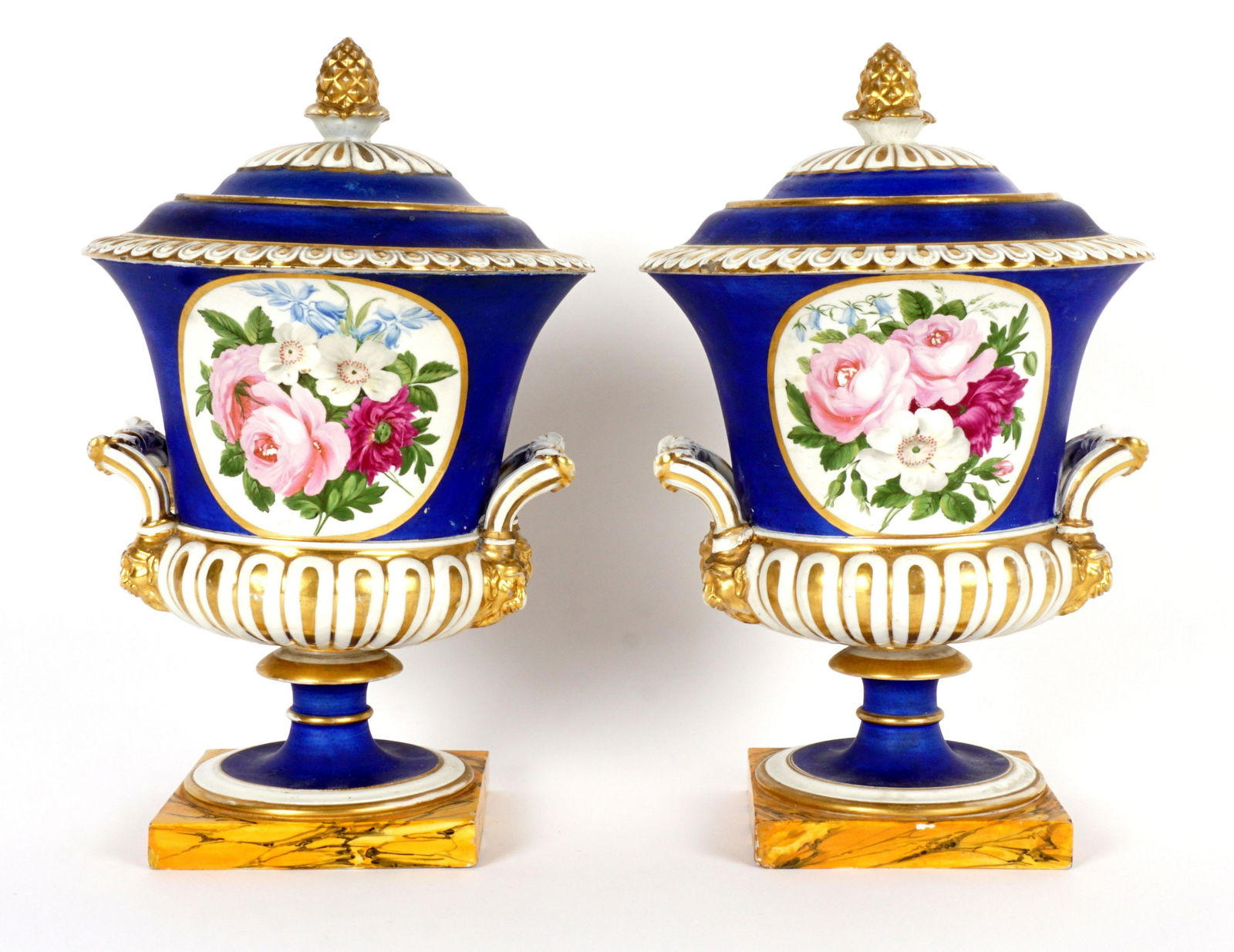 Pair Old Paris Covered Urn Garniture: 19th Century, each with cobalt blue ground, hand painted floral medallions, faux marble painted base, overall 11.5" h. x 7.5". Condition: Each with repairs to lids and handles, minor loss of decoratio
