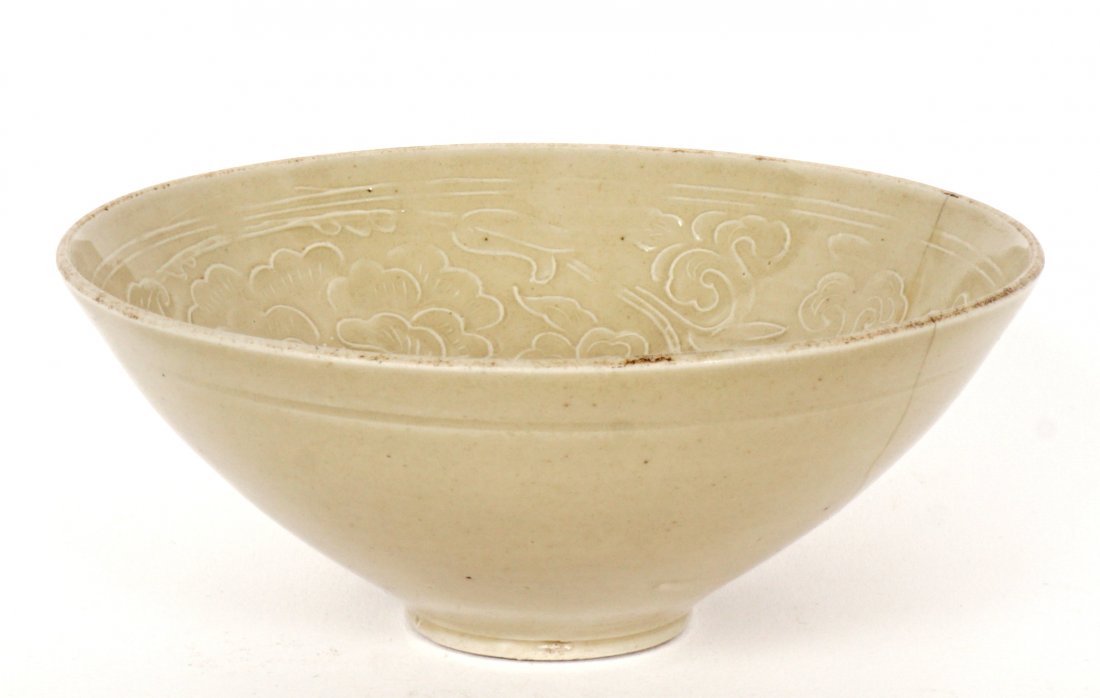 Chinese Song Dynasty Dingyao Bowl: Molded Dingyao bowl, Northern Song Dynasty, cream color glaze, interior floral motif, teardrop glaze exterior, 2" h. x 4.75". Condition: Repair.