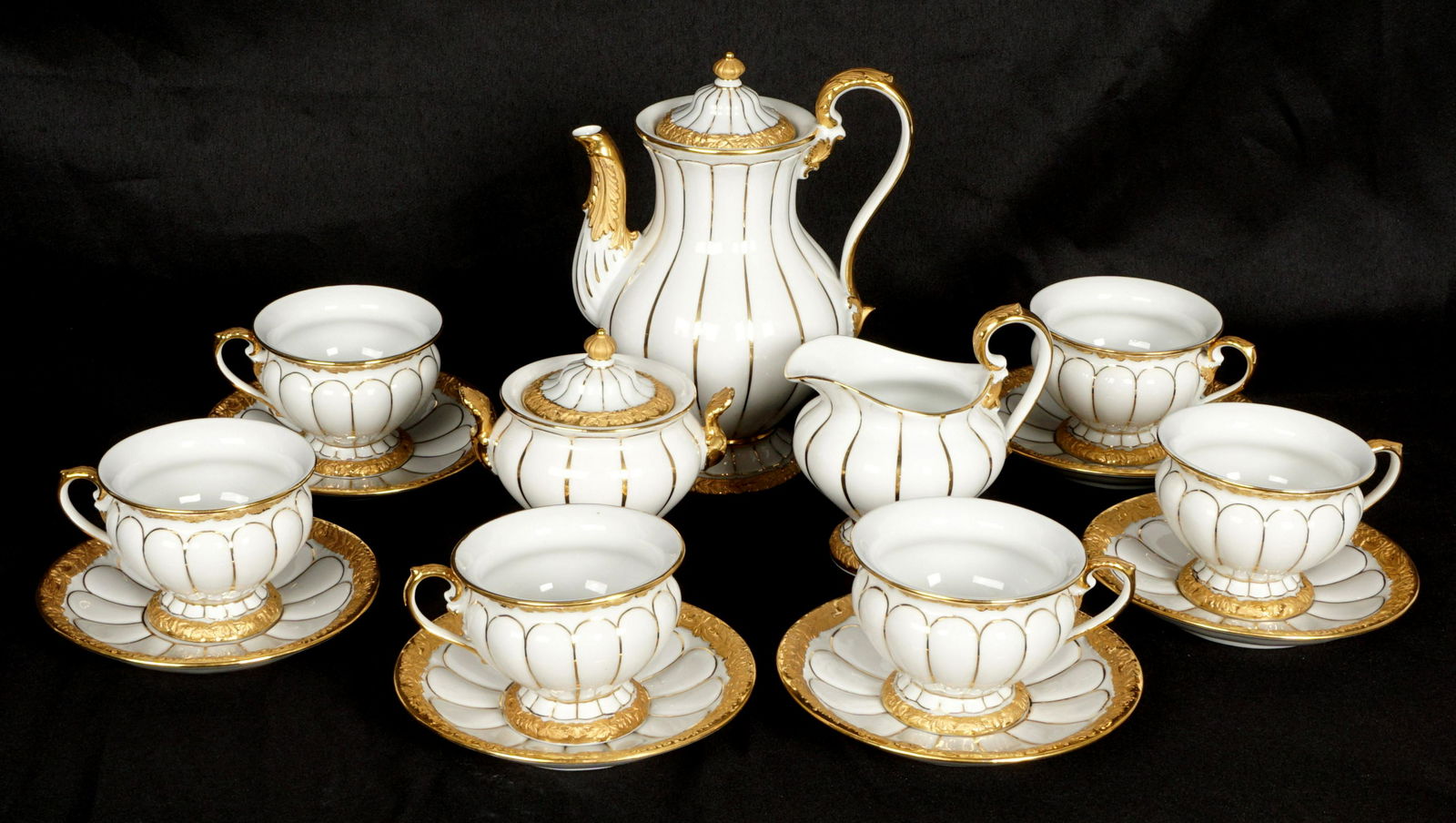 Meissen Gold Leaf Decorated Demitasse Set: Pattern 375 "Gold Leaf" by Meissen with blue crossed sword 2nd quality marks to include demitasse pot (7" h.), open creamer (4" h.), covered sugar (4"h. ), 6 cups (2.25" h) and 6 saucers 4.75" dia. Ov