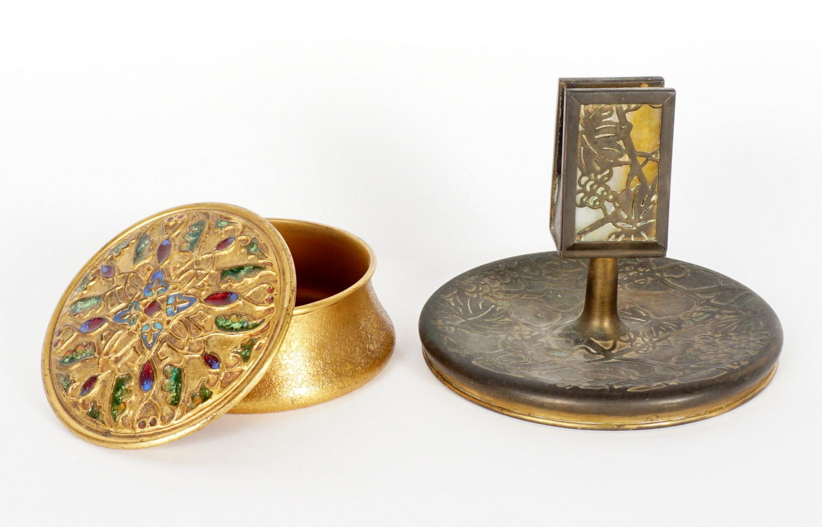 Tiffany & Co. Bronze Covered Box & Match Holder: Two piece total to include 1) Gilt bronze and enamel covered desk box signed Louis C. Tiffany Furnaces, Inc. 140. 2" h. x 4". There are two cracks to body. 2) Matchbox holder / ashtray in the Grapevin