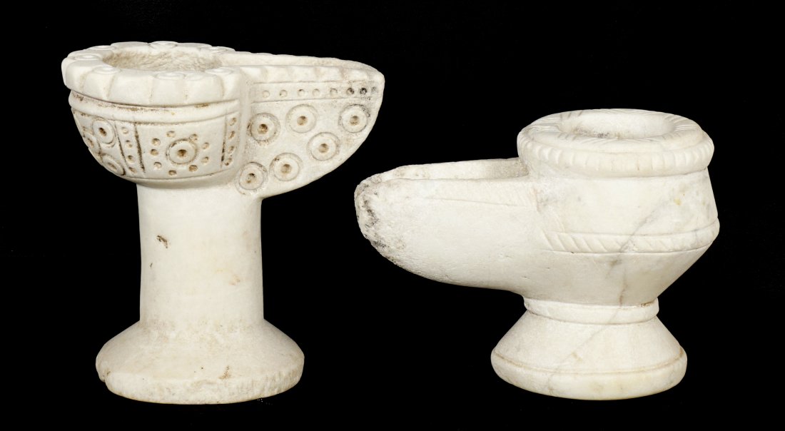 Two Islamic Carved Alabaster Oil Lamps: Two pieces total to include 1) Carved with repeating circle design, 5" h. x 4.75". Chip to base. 2) Incised lines 4" h. x 5.5". From a private Florida collection.