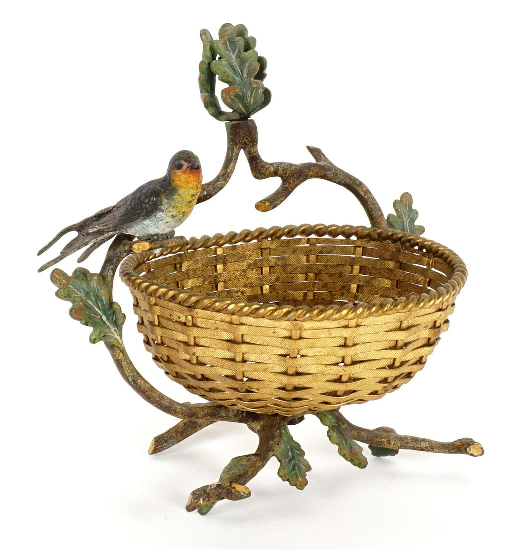 Austrian Cold Painted Bronze Bird Basket: Polychrome cold painted bronze twig from handle with leaves, single bird, and twig form base. Woven brass basket, no visible markings, overall 6.5" h. x 7".