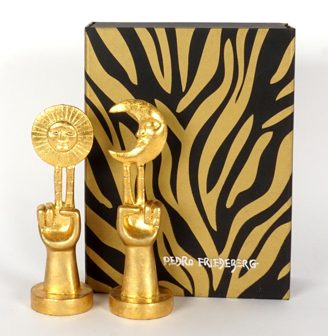 Pedro Friedeberg Pair Sun and Moon Sculptures: FRIEDEBERG, Pedro, (Mexican, 1936-): Two piece small carved gilt wood sculptures each with hand with two fingers raised, one with sun, the other with moon, signed on base under moon hand, 7.75" h. Sol