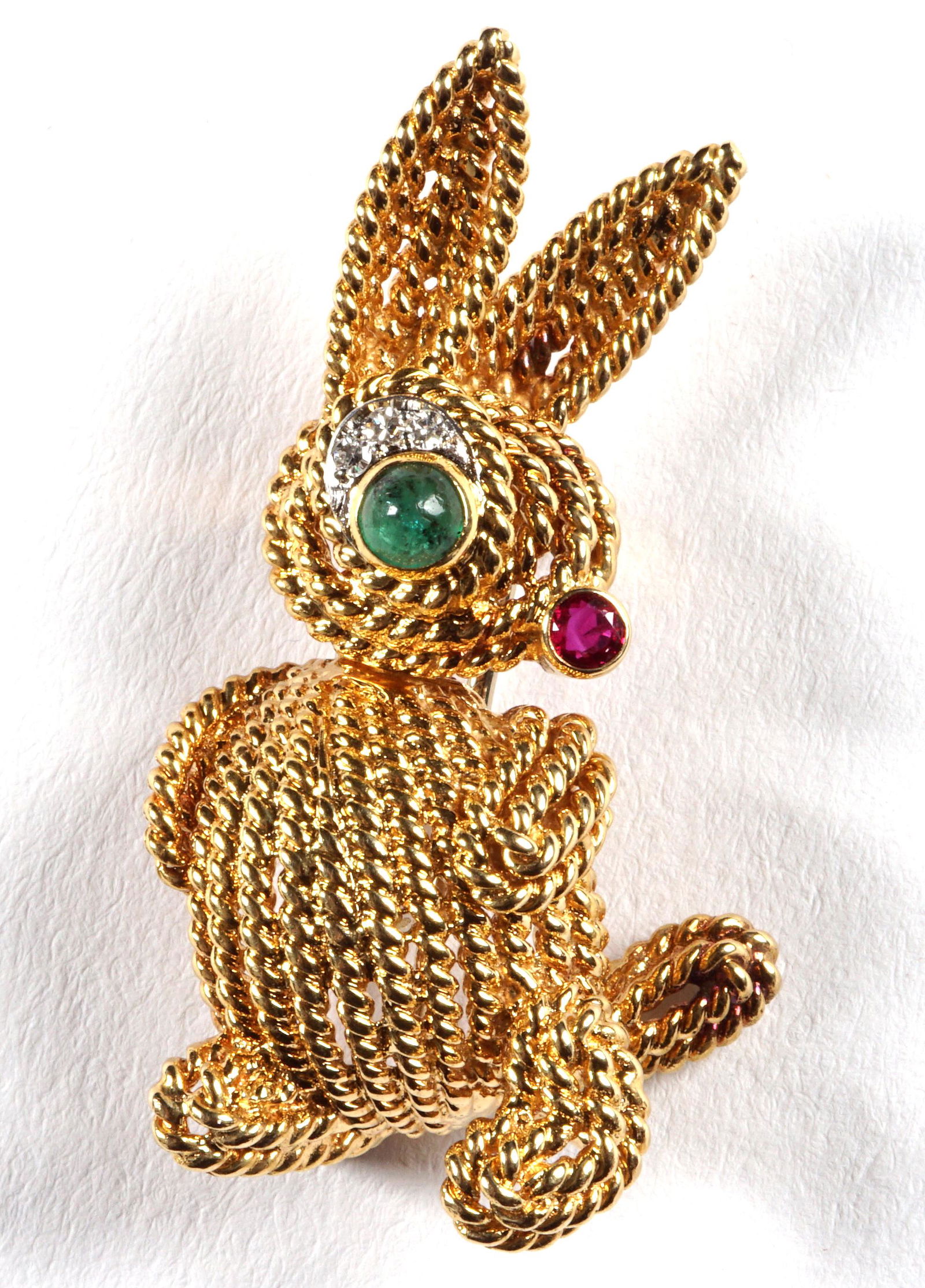 18k Gold Van Cleef & Arpels Rabbit Brooch: 18k twist gold body, cabochon set emerald eye, faceted ruby nose, three small diamonds eyebrow. Signed VCA, 93730, 750, Van Cleef cypher in lozenge, overall 1.5" h., approx. 11 grams inclusive.