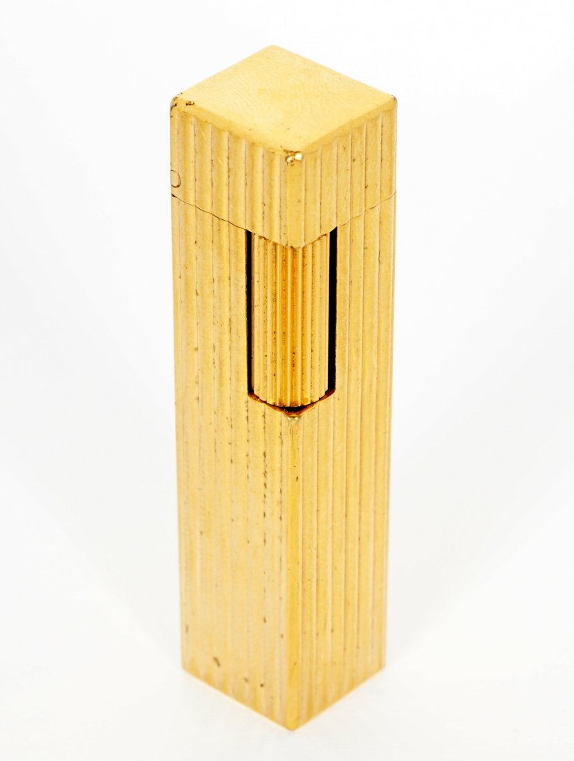 Sylvia Miles Gold Plated Cartier Lighter: From the Sylvia Miles estate, rectangular ribbed gold plated lighter well marked Cartier, flint still works, 2.5" long.