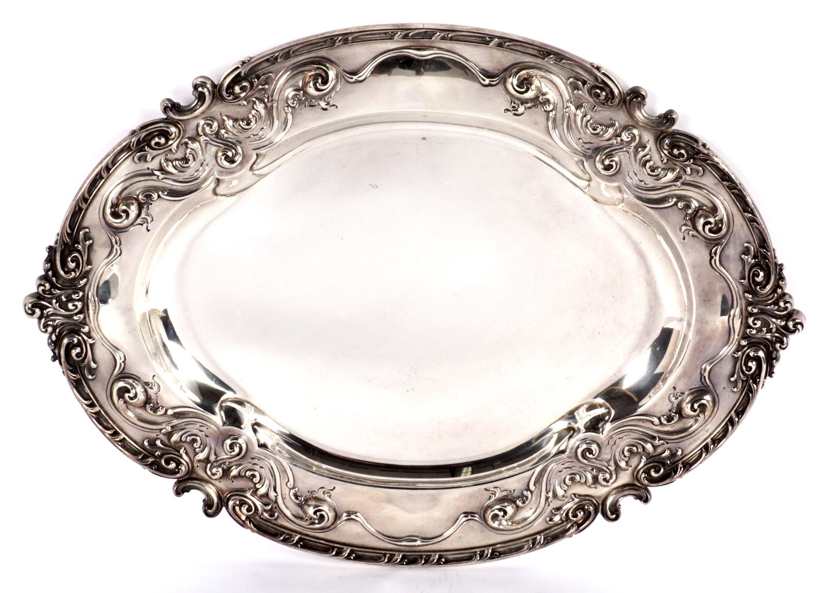 Large J.E. Caldwell Sterling Silver Serving Tray: Embossed raised foliate scroll rim, well marked Sterling, 1835, 20 IN, J. E. Caldwell. Measures 21.25" x 17.75". Approx. 52.5 troy oz. Condition: Scratches
