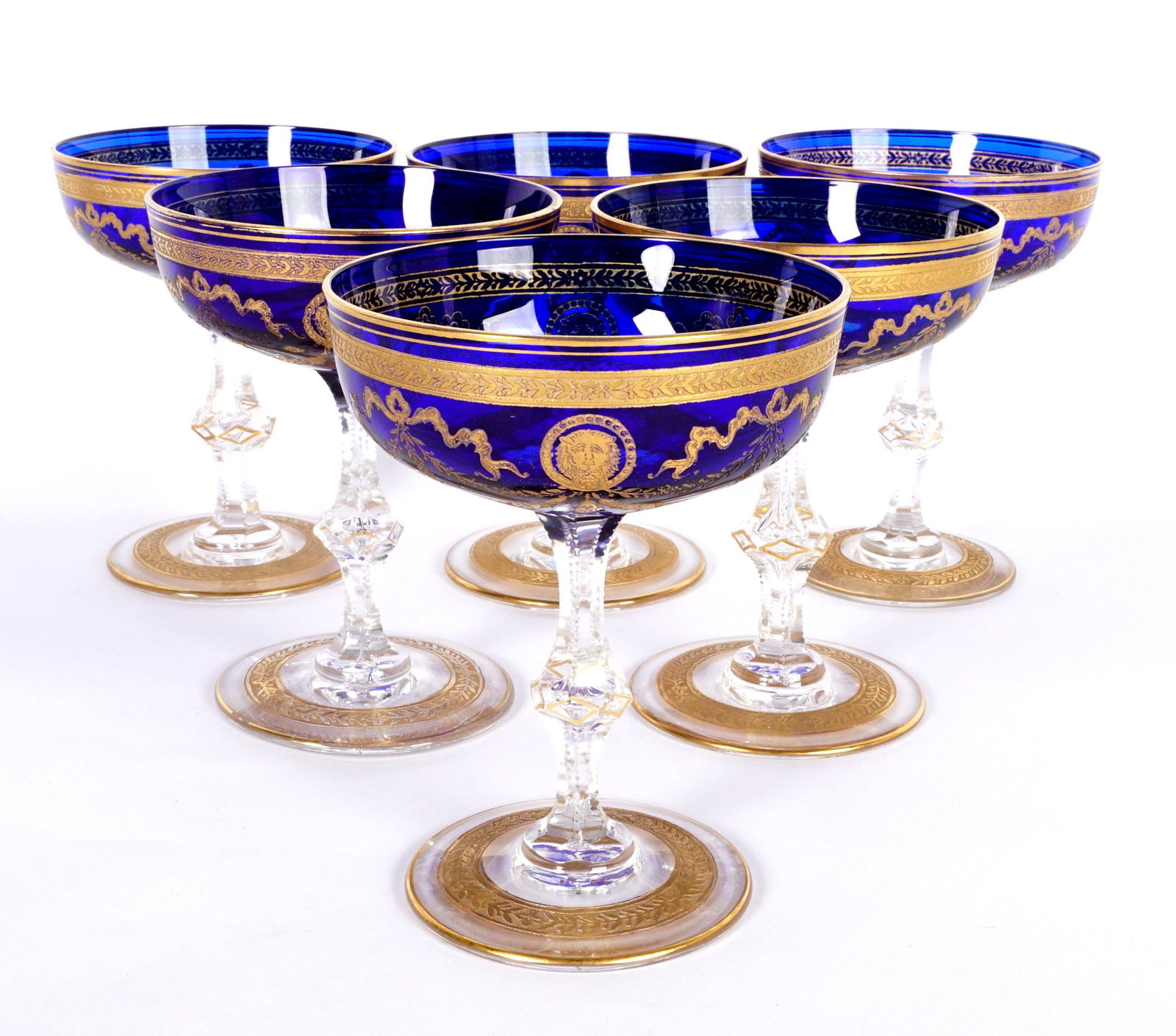 Rockefeller Estate Six Cobalt & Gilt Champagne Glasses: Cobalt blue bowl, gold gilt decoration, cut clear stem, gilt decorated foot, unmarked, Moser quality, 4.75" x 3.75" dia. From the Elisabeth Rockefeller Bowler Estate, great granddaughter of Franklin R