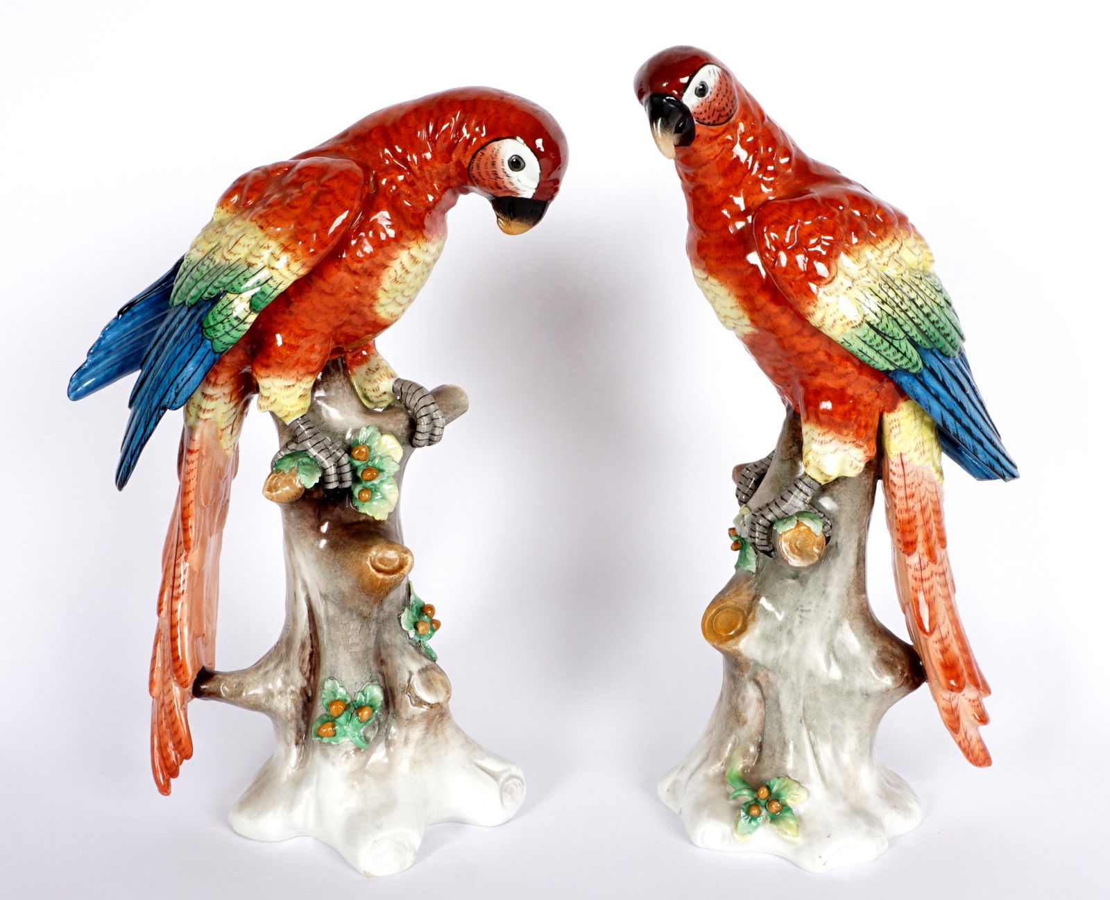 Pair Sitzendorf Porcelain Figures of Macaws: Pair of porcelain macaws on tree stumps, signed with Sitzendorf blue mark on base, taller 13.5" h. x 9".