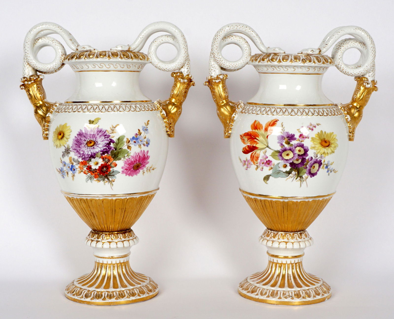 Pair Meissen Snake Handle Porcelain Vases: Elaborate coiled snake tassel handles, baluster form bodies with hand painted floral decoration, Foot with blue crossed swords mark, impressed 98 and incised E 116. Overall 15.5" h. x 10". Condition: