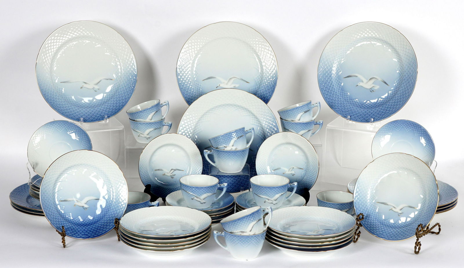 Bing & Grondahl Seagull China Service: A nearly complete set of pieces total in the Seagull pattern by Bing & Grondahl to include 11 dinner plates (10.25"), 12 salad plates (7.5"), 12 bread plates (6.25"), 12 cups and saucers. Set appears