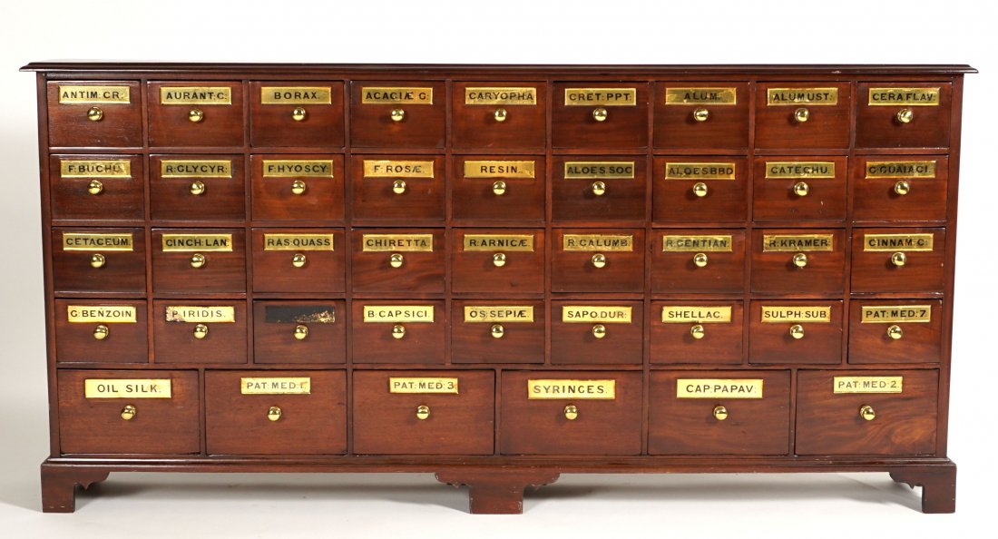 Large 19th Century Mahogany Apothecary Cabinet: Mahogany cabinet, 42 drawers with brass pull and handles, overall measures 32.75" h. x 74.5" x 11". Condition: Scratches to top, missing one brass plaque.