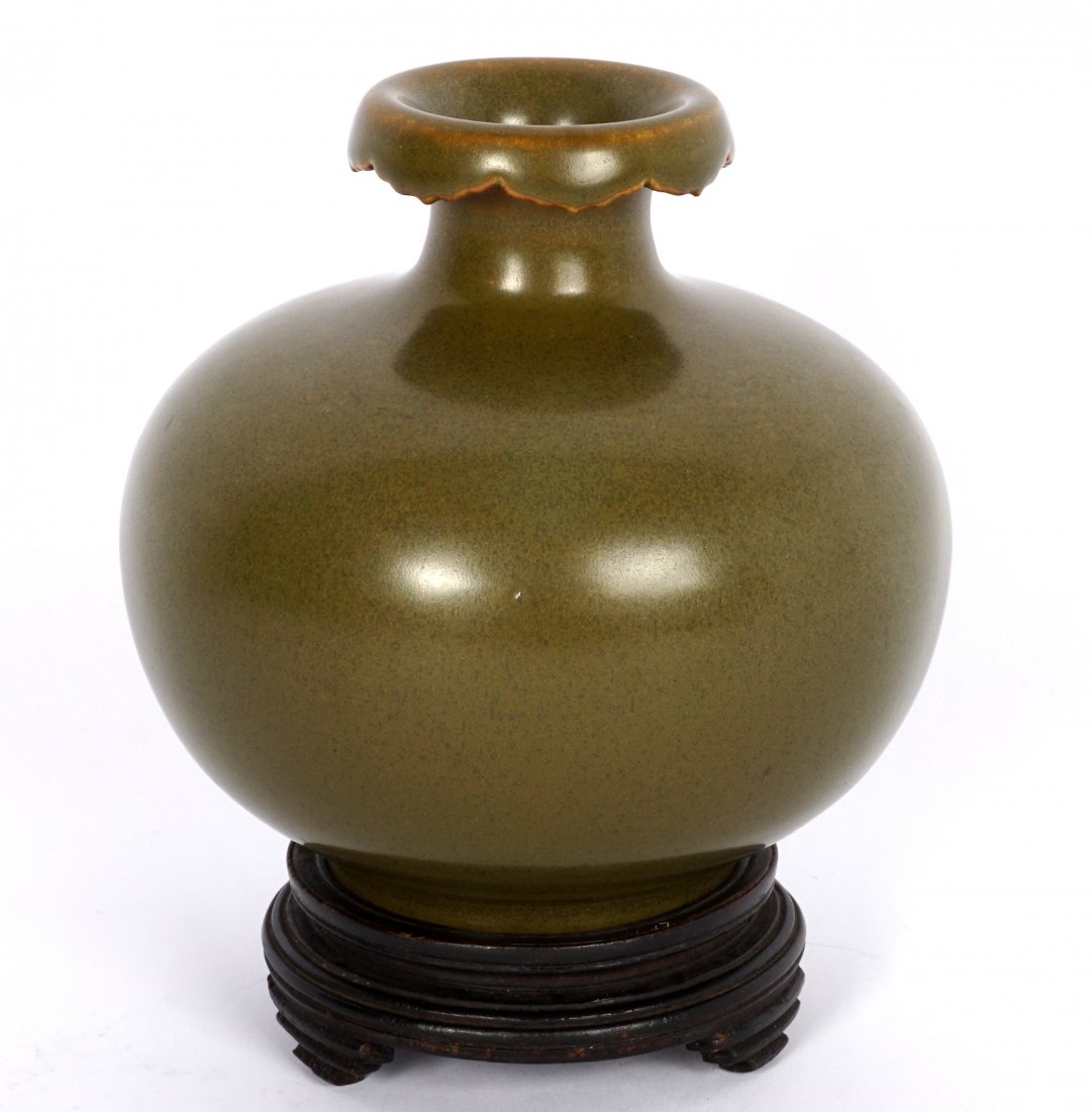 Chinese Qianlong Marked Teadust Glazed Vessel: Squat vase form with folded and scalloped rim, bears a Qing Qianlong impressed stamp on base, measures 5" h. x 5" dia. Sold with a wood stand bearing G.F.S. Keen-Lung No. 295 label.