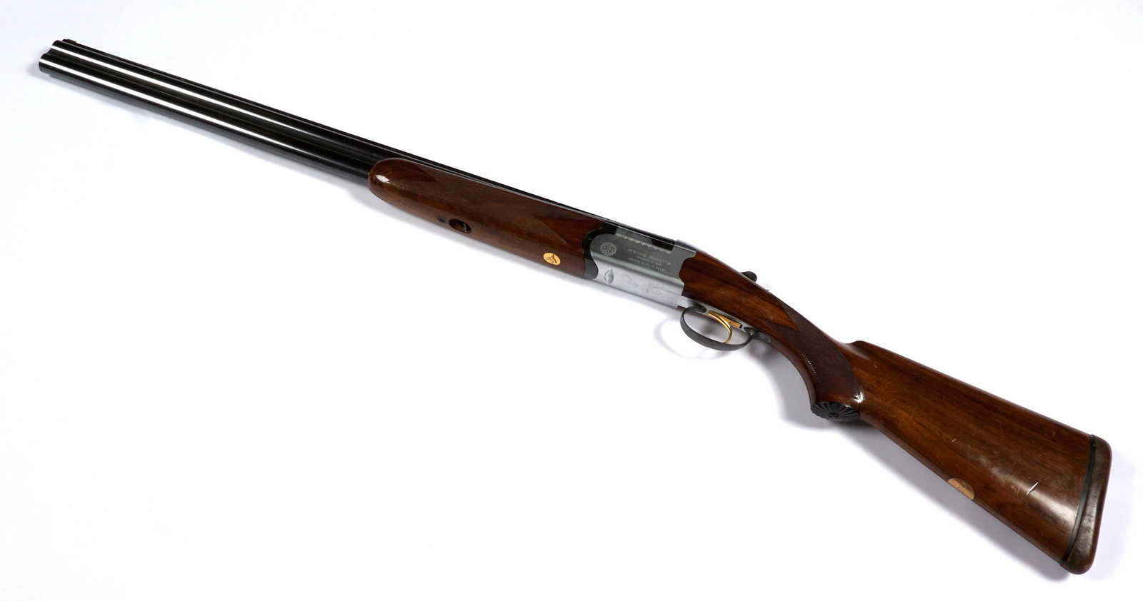 Pietro Beretta Golden Snipe 12 Gauge Shotgun: 12 gauge over -under barrels, 26.25" blued barrels, engraved stainless steel receiver, gold plated trigger, stock decoration a,d monogrammed plaque, leather covered butt. Overall 43", length of pull 1