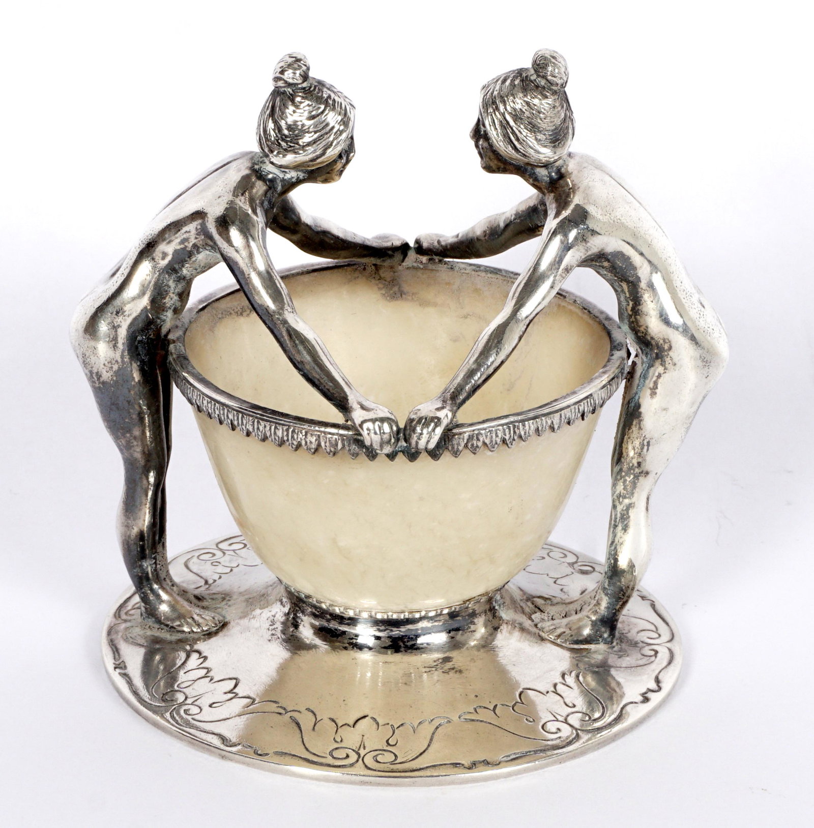 Cartier Silver and Jade Figural Nude Match Holder: Silver figures of standing nude women flanking a white jade or similar stone cup. Engraved foot, signed Cartier on base. 3.25" h. x 3.25".