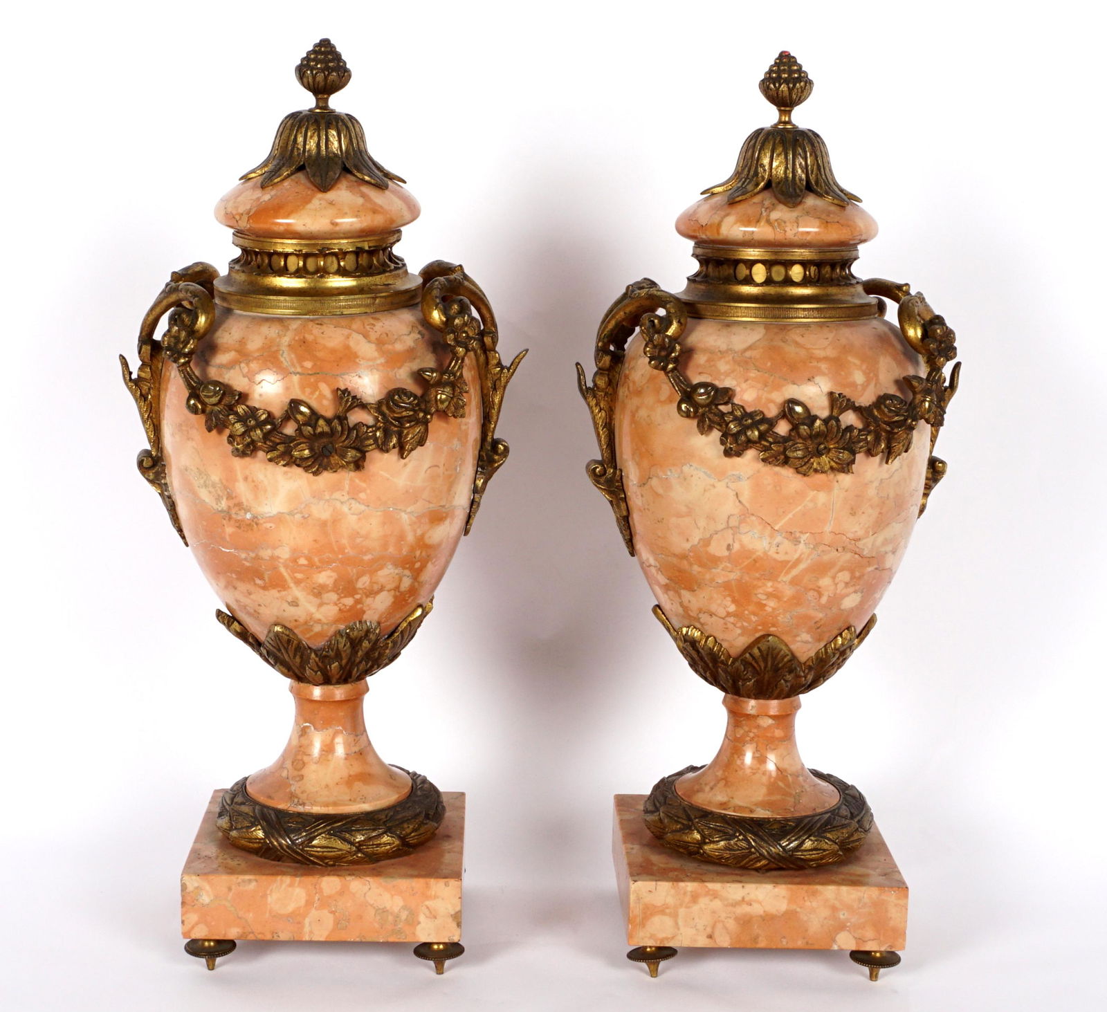 Pair French Louis XVI Bronze Mounted Urns: Pink variegated marble mounted with bronze foliate garland and accents , on 4 feet, 16.75" x 7.5".