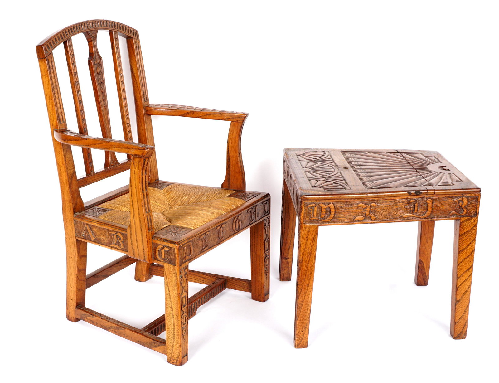 Early 19th C. French Childs Carved Chair Table: Matching chair and table affixed together with screw peg. Chair with rush seat, carved back, arms, and legs. Skirt with letters of the alphabet. Table top with carved sunrays, skirt with remaining let