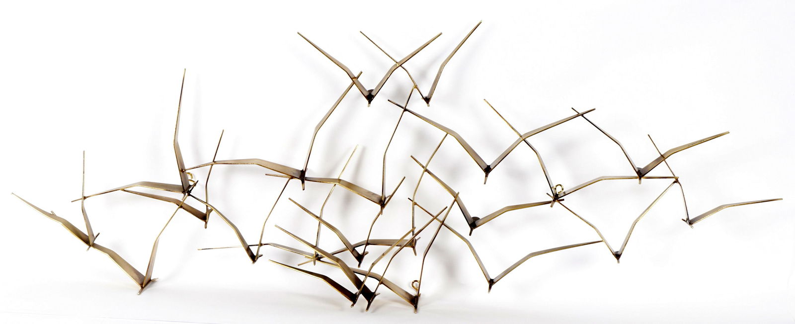 1987 Curtis Jere Birds in Flight Wall Sculpture: Brass finish, large wall sculpture featuring seagulls in flight, signed and dated 1987. Overall 21.25" h. x 58.25" x 6".
