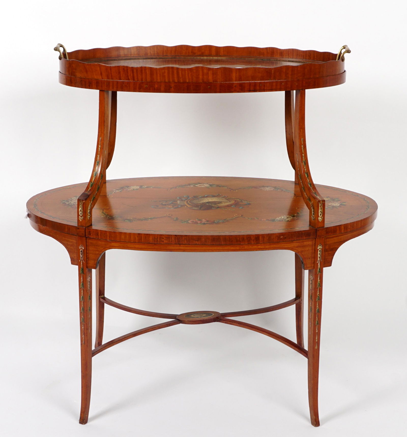 Edwardian Paint Decorated Two Tier Tray Table: Removable glass two handled tray top, over two tier satinwood table, paint decorated with musical instruments and floral garland. Shaped supports, stretcher, and legs, overall 35.25" h. x 35" x 22". C