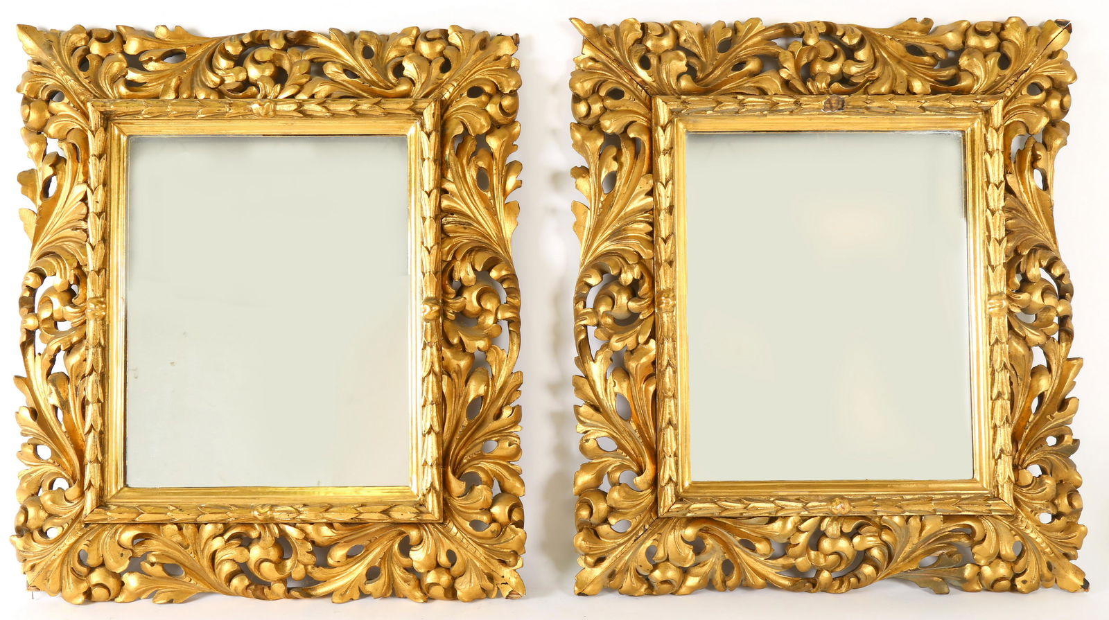 Pair Continental Gilt Wood Mirrors: Most likely Spanish or Italian, carved foliate scroll gilt wood frames, measures 25.5" h. x 23" x 2.5". Condition: Chips and loss to frames and gilt.