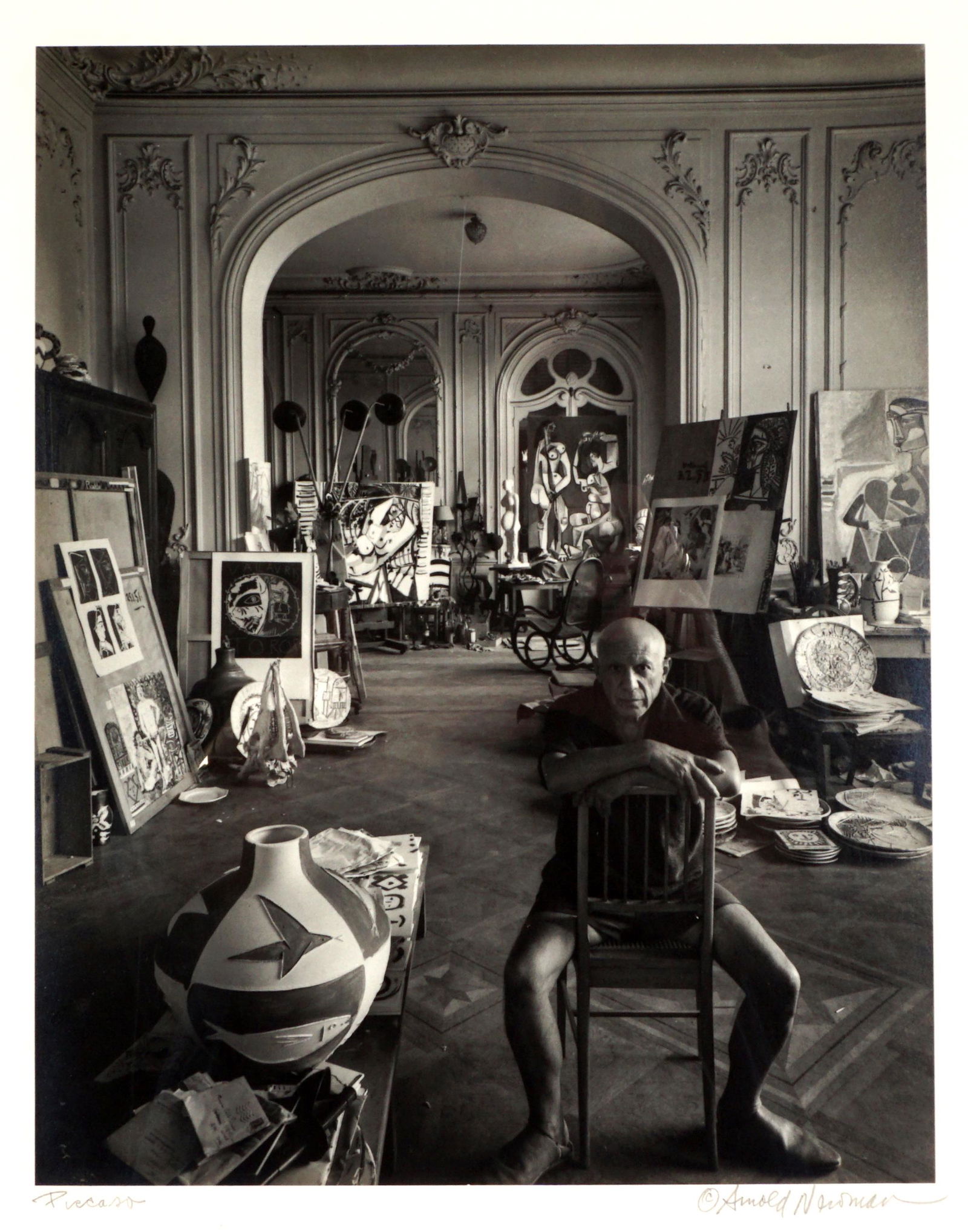 1956 Arnold Newman Pablo Picasso Photograph: NEWMAN, Arnold, (American, 1918-2006): Silver gelatin print of artist Pablo Picasso in his loft, circa 1956, pencil signed under photograph on right, title Picasso left, Arnold Newman copyright sticke