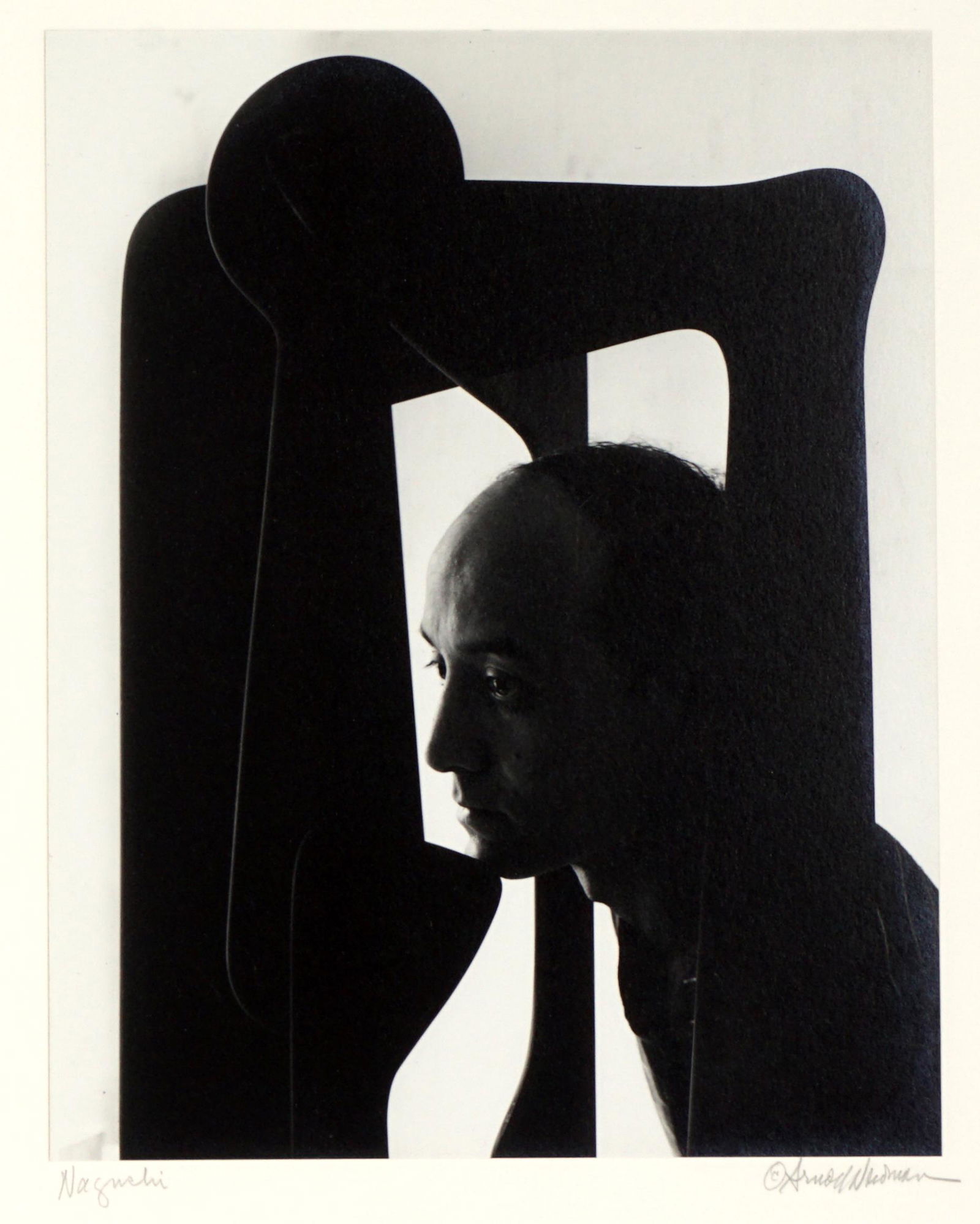 1947 Arnold Newman Isamu Noguchi Photograph: NEWMAN, Arnold, (American, 1918-2006): Silver gelatin print of artist and furniture designer Isamu Noguchi in profile, circa 1947, pencil signed under photograph on right, title Noguchi left, Arnold N