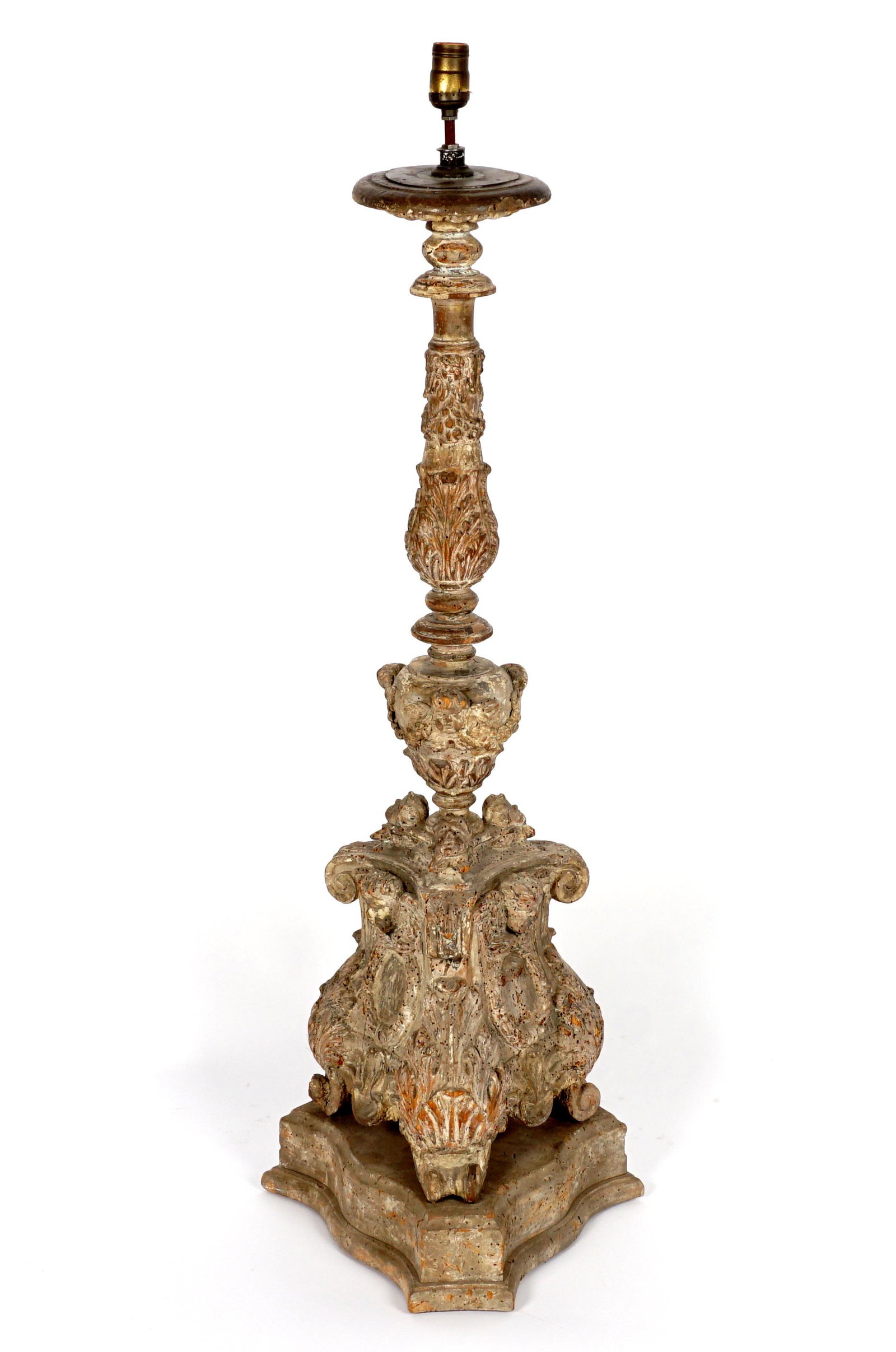 Large 18th Century Carved Italian Pricket Lamp: 18th Century tall rococo style carved pricket stick mounted as a lamp, traces of white paint decoration, single socket fixture, overall 44" h. x 14". Condition: Chips and dings, evidence of prior inse