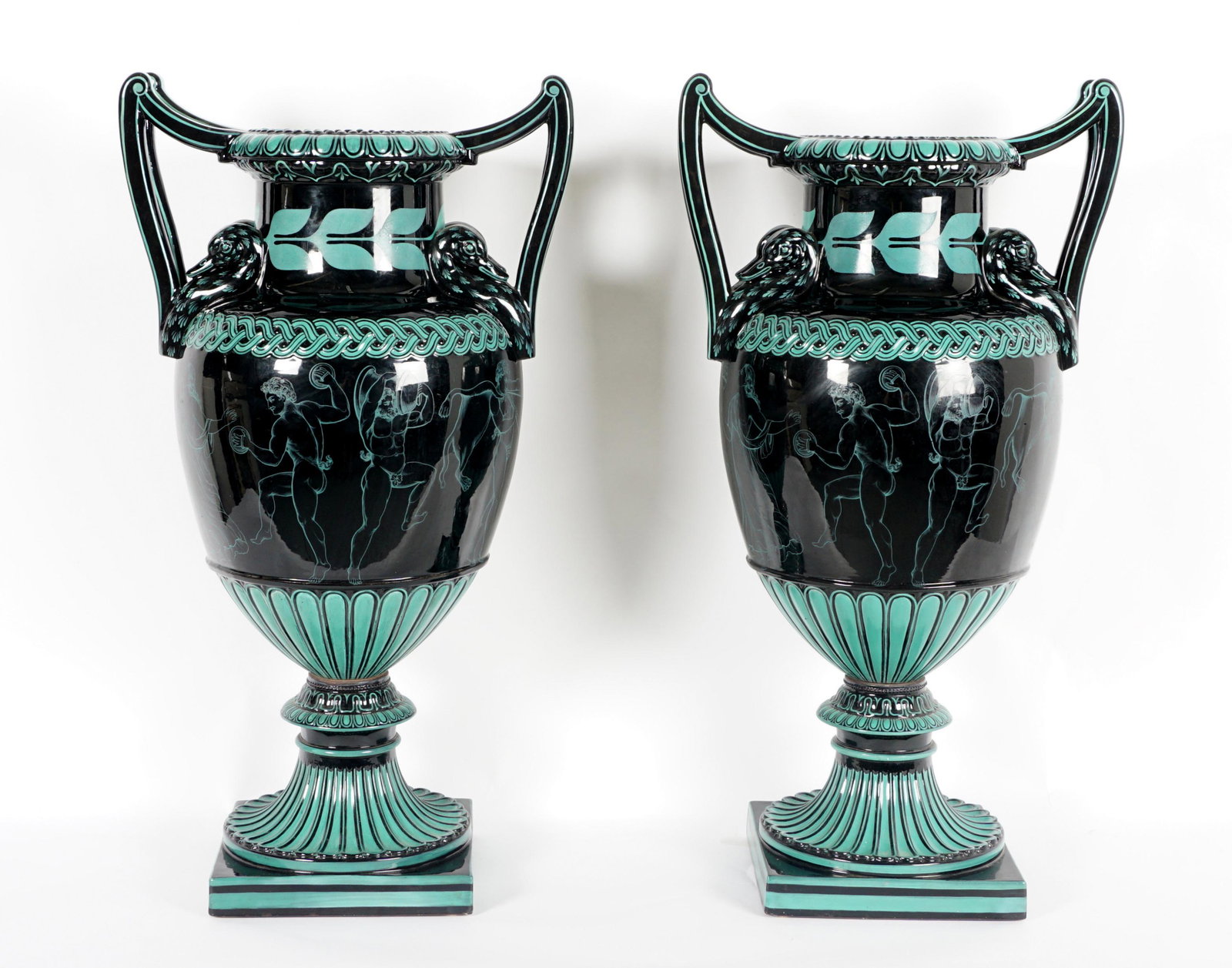 Pair Neoclassical Terracotta Urns: Early to mid 20th Century, sculpted handles with figural swan heads at body, repeating neoclassic style band, ribbed base, overall 23" h. x 17.5". Condition: Looseness at bases.