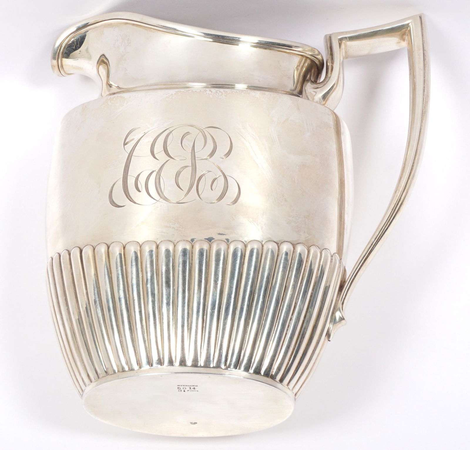 Whiting Sterling Silver Pitcher: Regency style water pitcher by Whiting, ribbed lower half, monogrammed, well marked on base with Whiting cypher, Sterling, 5014, 3 1/2 pints. Overall 8.25" h. x 7.75" x 4". Approx. 17.5 troy oz. Condi