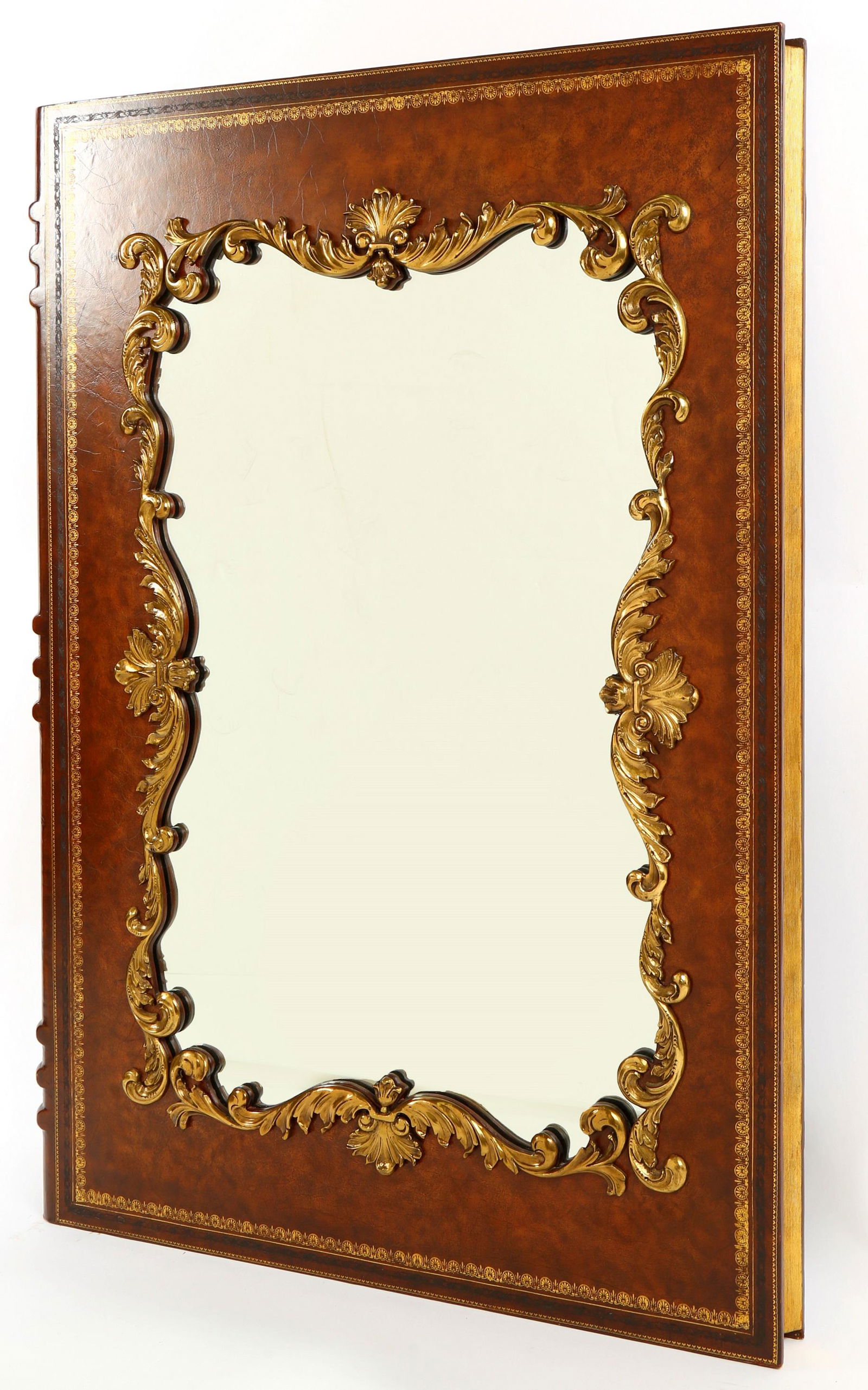 Large Maitland Smith Book Wall Mirror: Embossed leather book form wall mirror, gilt metal accents, Maitland-Smith label verso, 48" h. x 34" x 3.75".